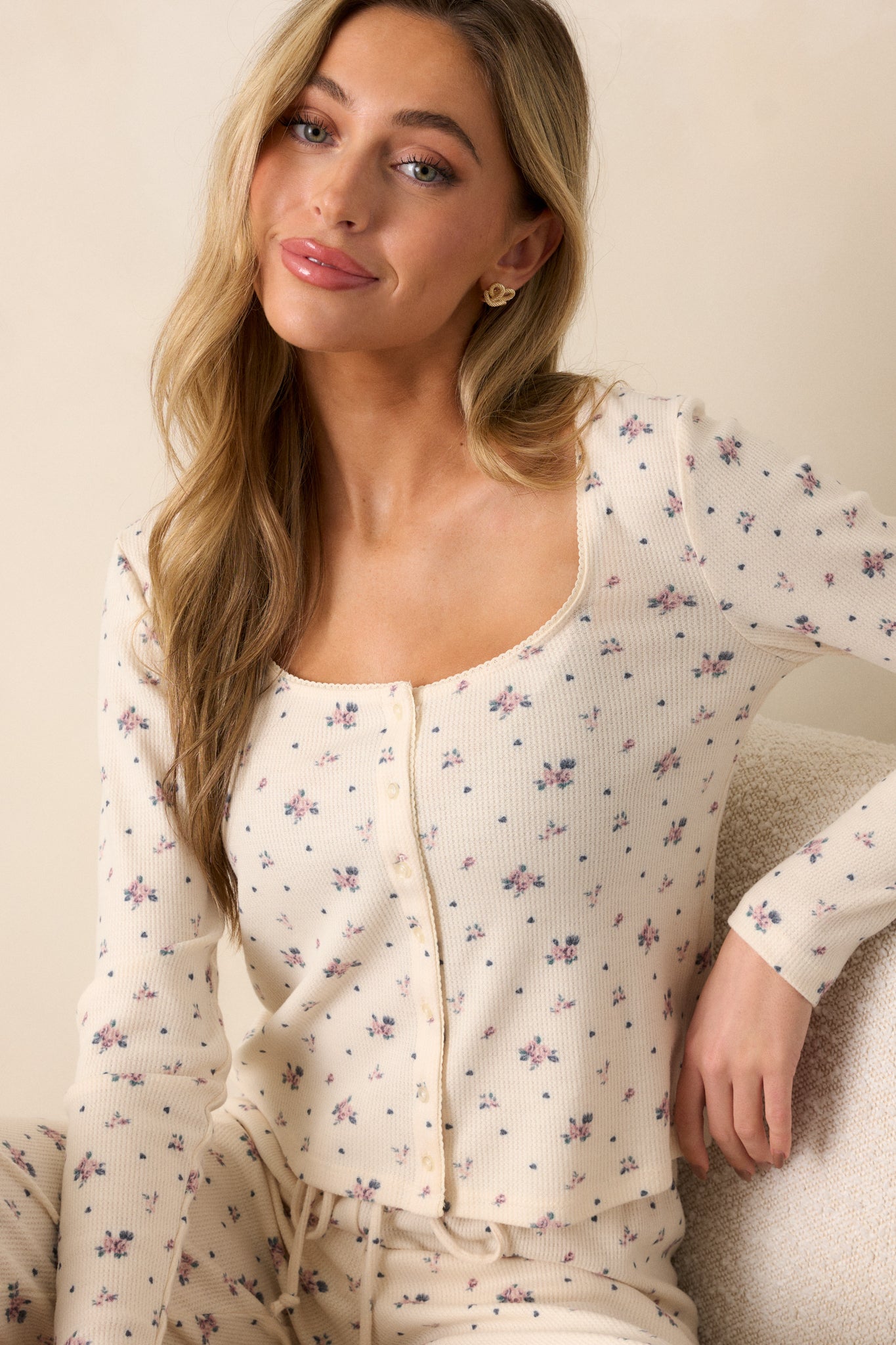 Close-up of the ivory top showing the scoop neck and intricate floral ditsy rose print across the chest area.