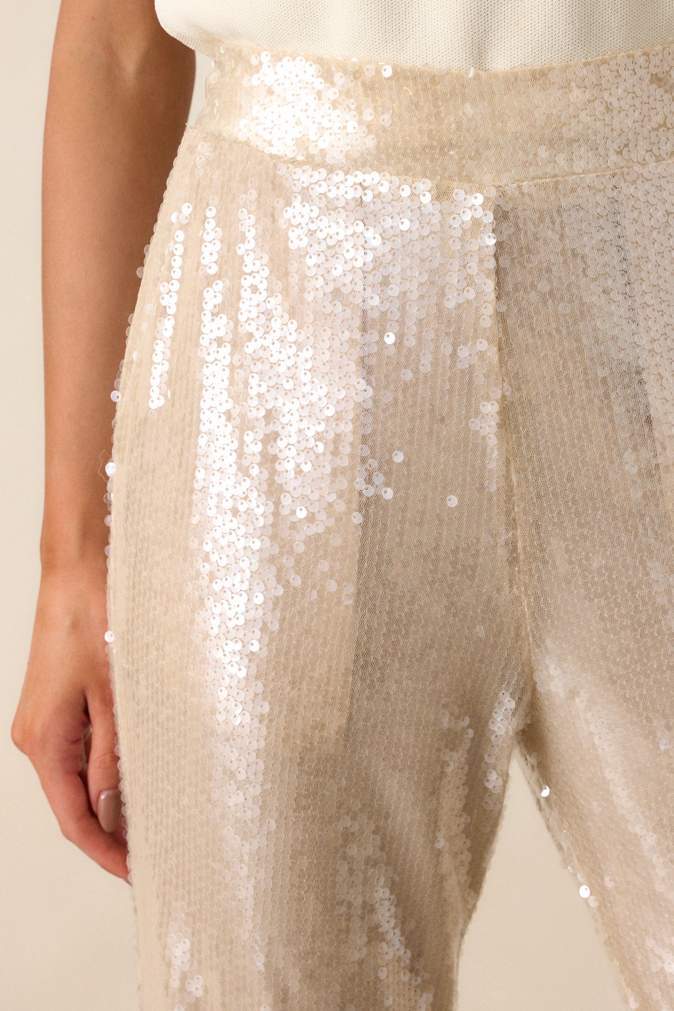 A zoomed-in shot of the sequins, emphasizing their texture and sparkle, as well as how they are evenly distributed across the fabric.