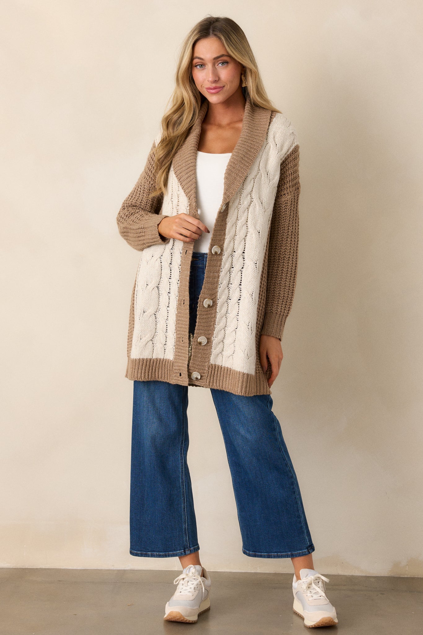 The cardigan displayed with its long sleeves and ribbed cuffs visible, highlighting the relaxed, cozy fit.