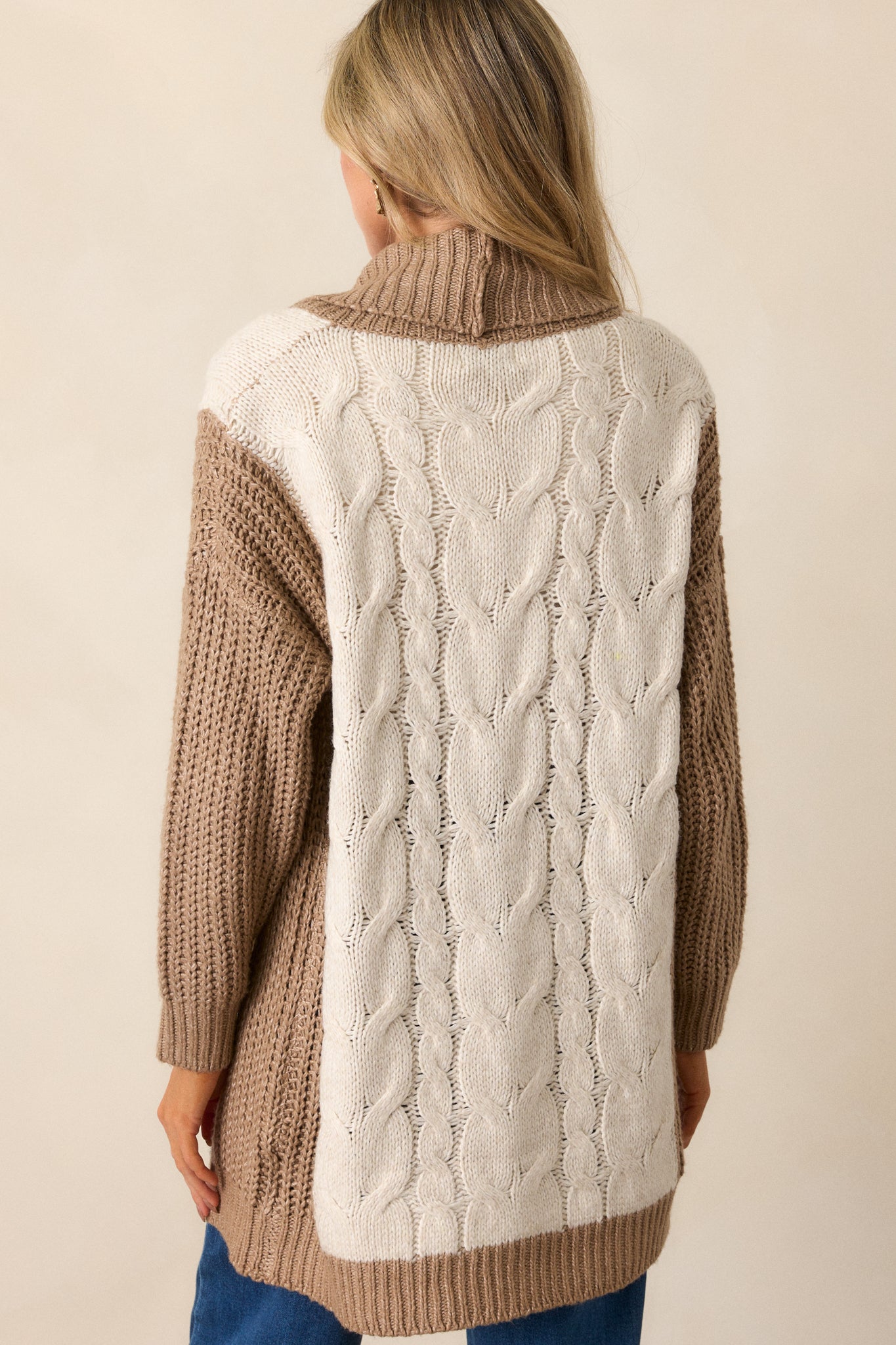 View of the back of the cardigan, featuring the smooth, oversized fit and subtle drape of the fabric.