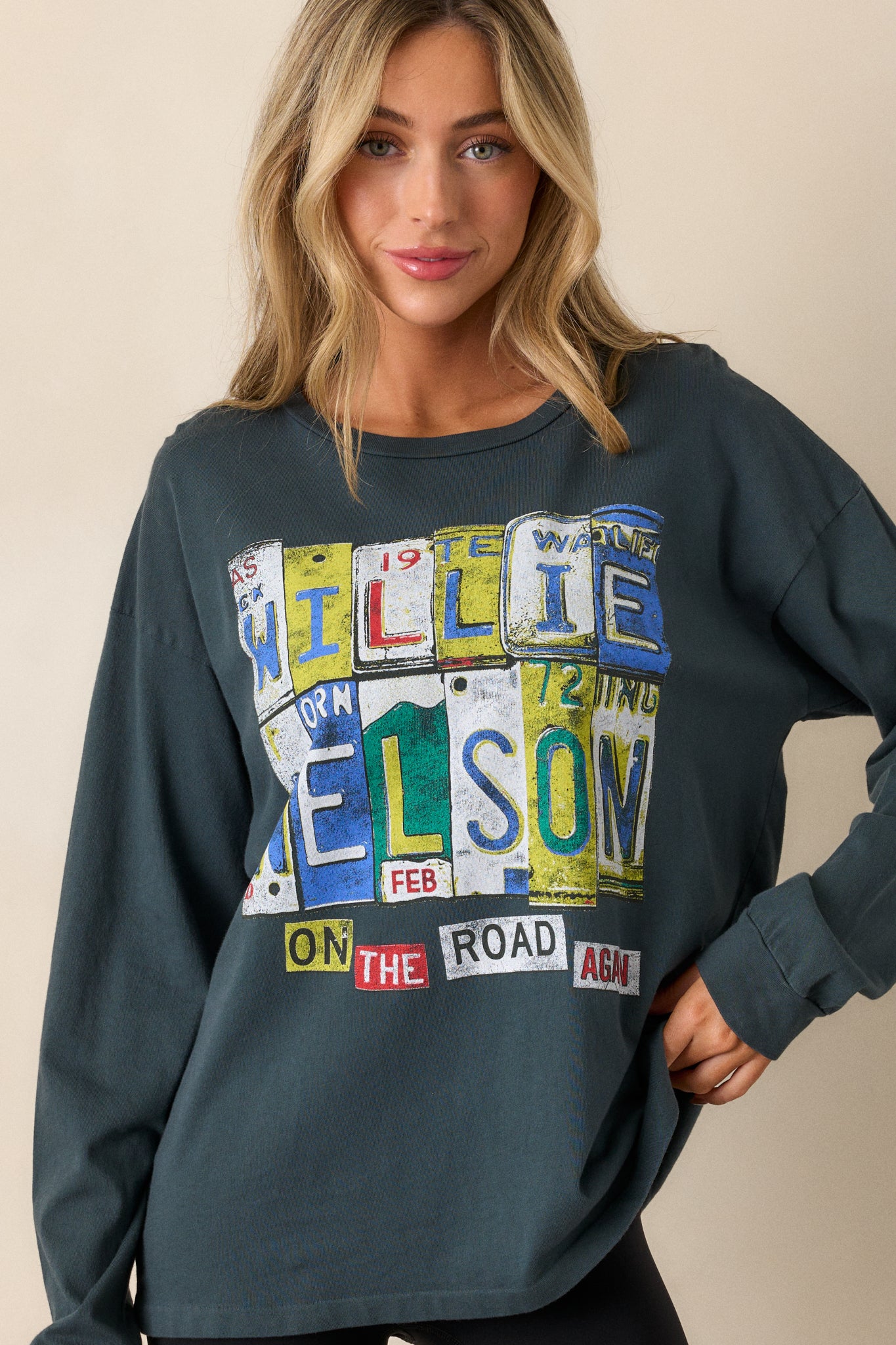 A front view highlighting the relaxed fit of the tee, long sleeves, and the bold Willie Nelson graphic. The crew neckline frames the face and adds structure to the relaxed look.