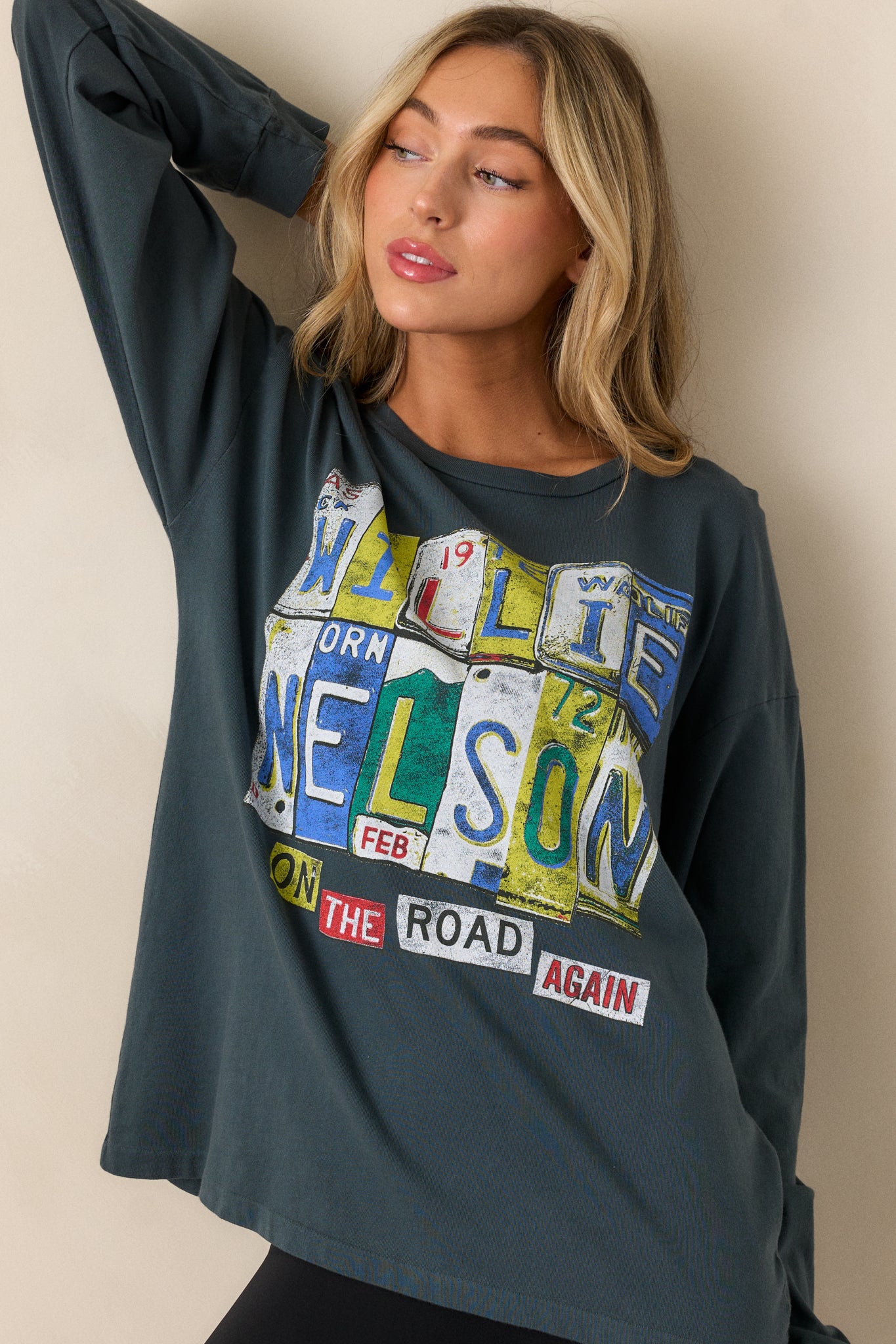 A cropped view that highlights the relaxed fit and long sleeves, with the graphic "Willie Nelson On the Road Again" visible across the chest. The soft fabric is shown draping naturally.