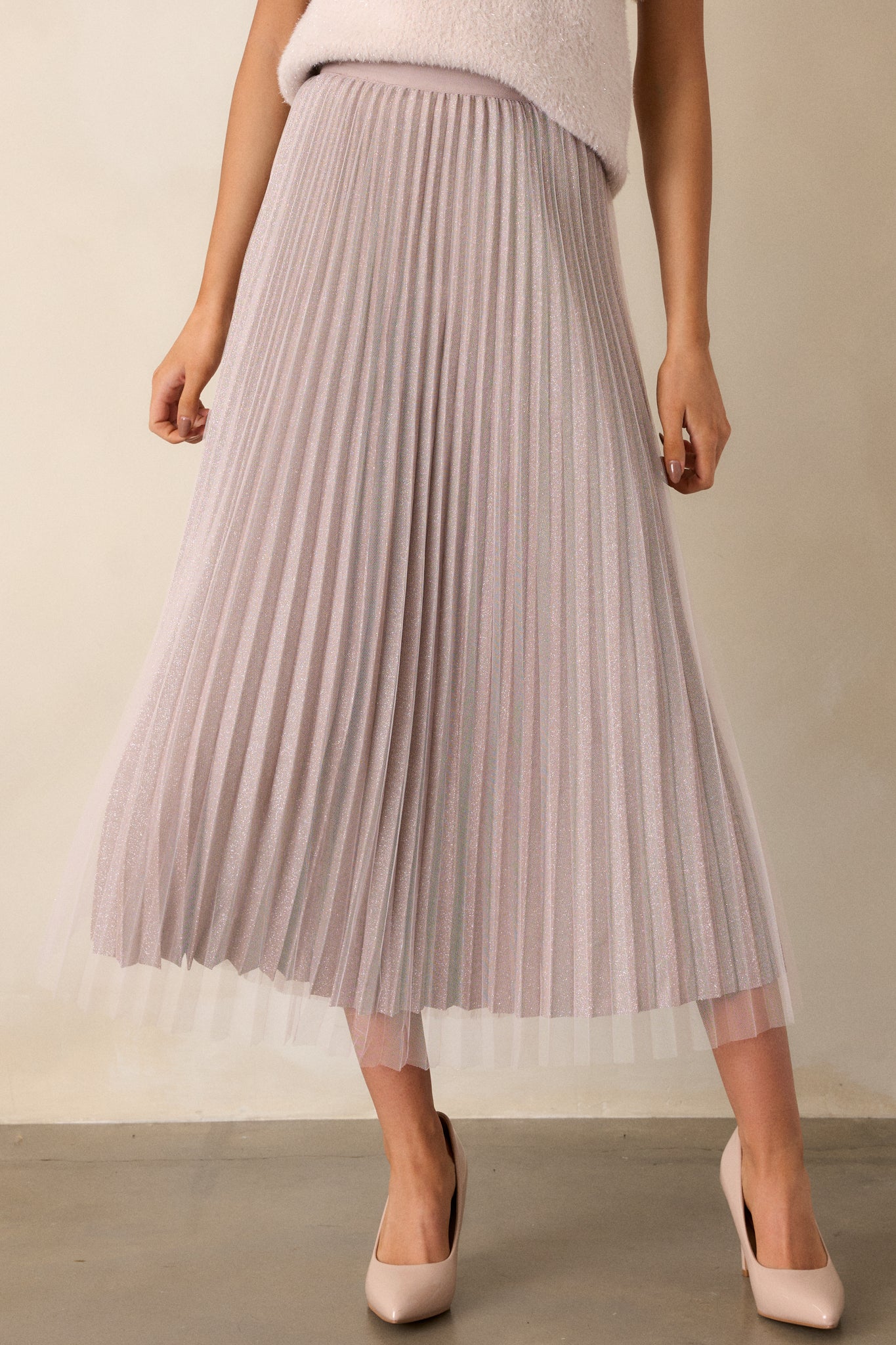 A full view of the mauve skirt, highlighting its midi length, pleated shimmer underlay, and soft tulle overlay