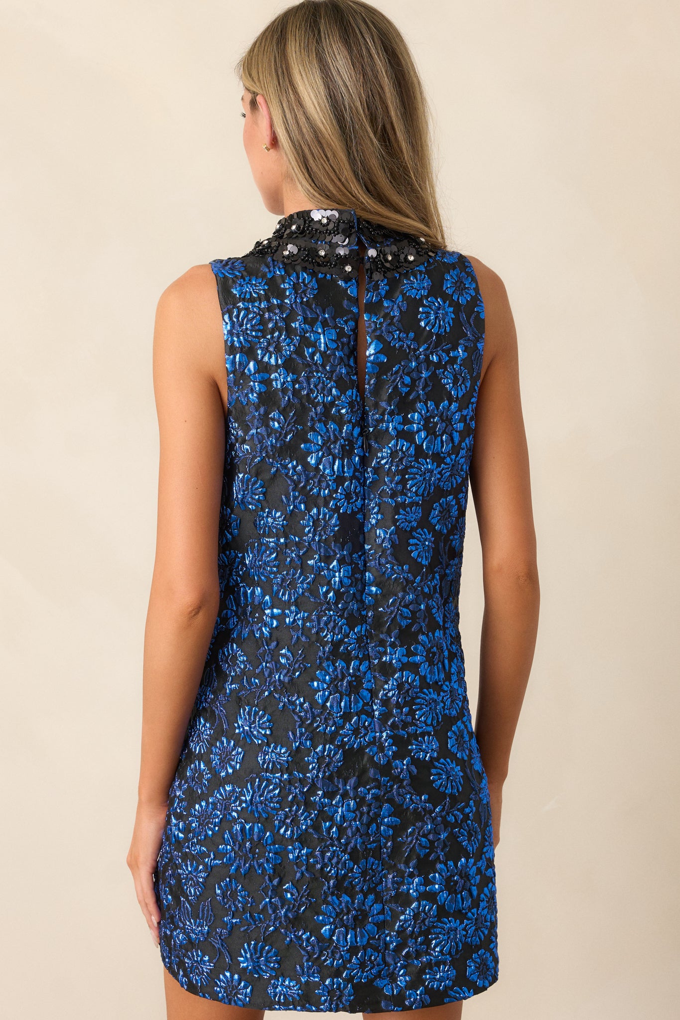 Back view focusing on the discrete back zipper and the smooth flow of the jacquard fabric, with the mini dress’s structured yet comfortable design visible.