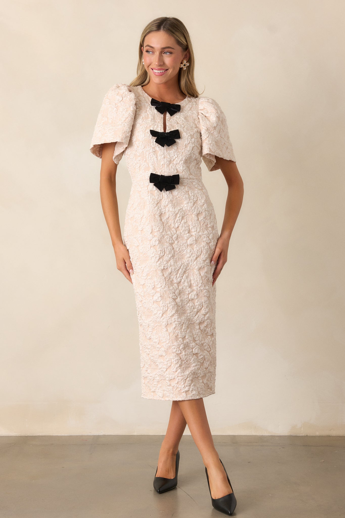 A wide front view of the dress, capturing its overall silhouette, short sleeves, and graceful design.