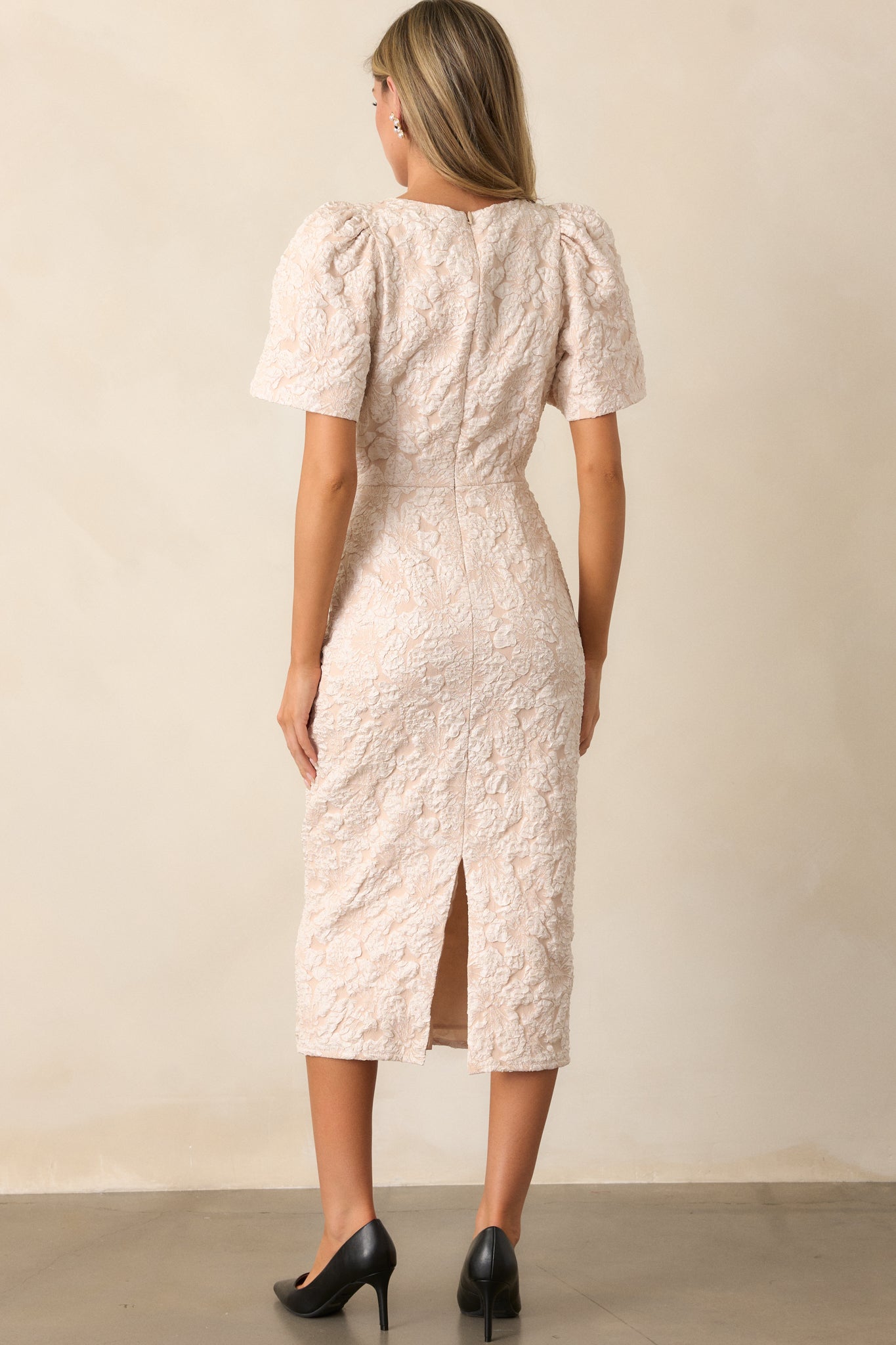 A back view of the dress showcasing the smooth jacquard fabric, short sleeves, and the discrete back zipper.