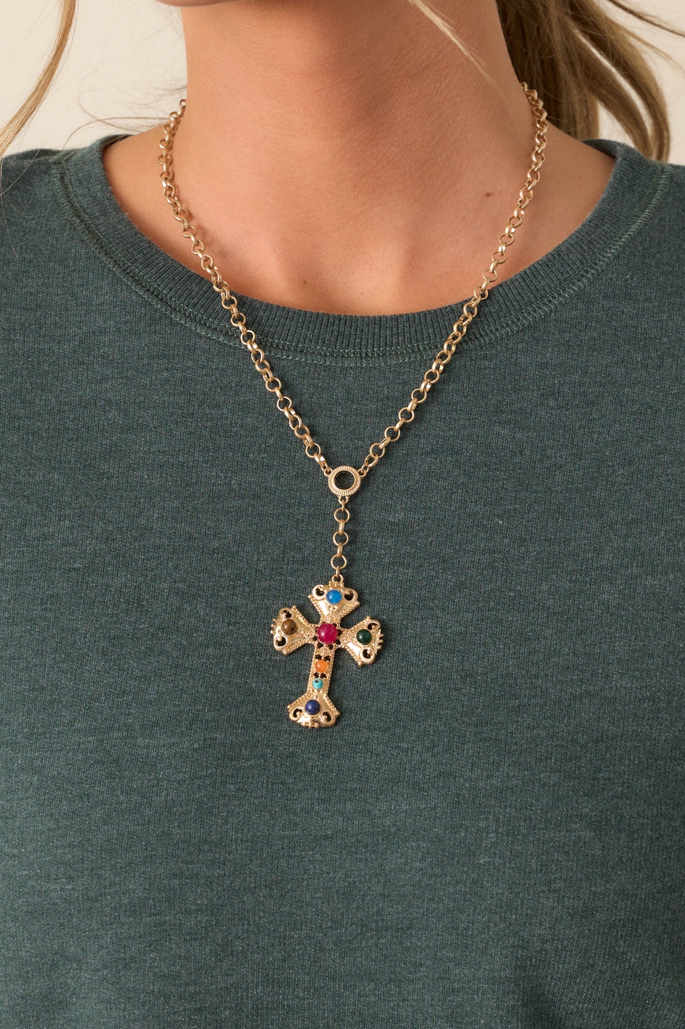 Front shot focusing on the cross-shaped pendant adorned with multi-color faux pearls, emphasizing the texture of the pendant and the luminous quality of the pearls.