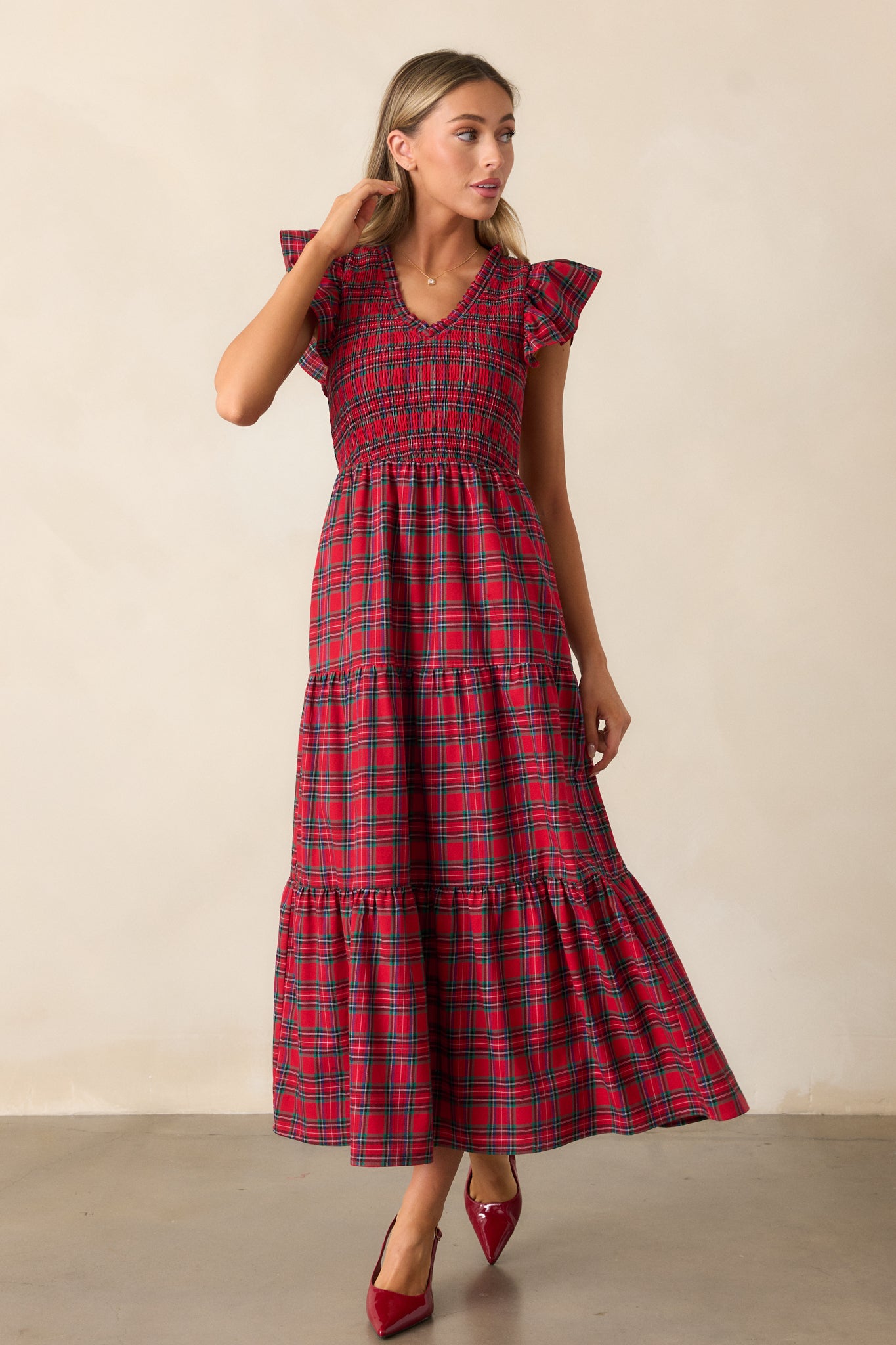 Front view of the red dress showcasing the relaxed fit of the tiered skirt and delicate plaid pattern.