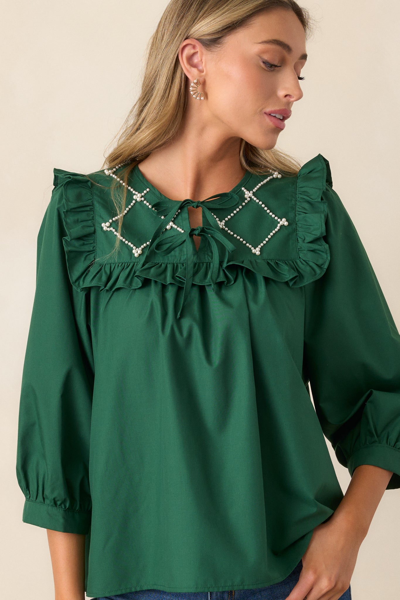 Front view of the hunter green top, showcasing the faux pearl lattice yoke with ruffle detailing, keyhole neckline with two self-tie bows, and 3/4 length puff sleeves.