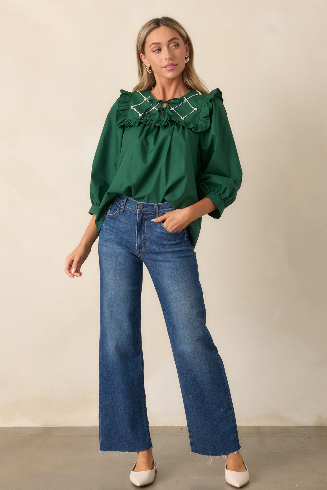 Another front view of the hunter green top, with the focus on the structured ruffle detailing on the faux pearl lattice yoke, 3/4 length puff sleeves, and the self-tie bows on the keyhole neckline.