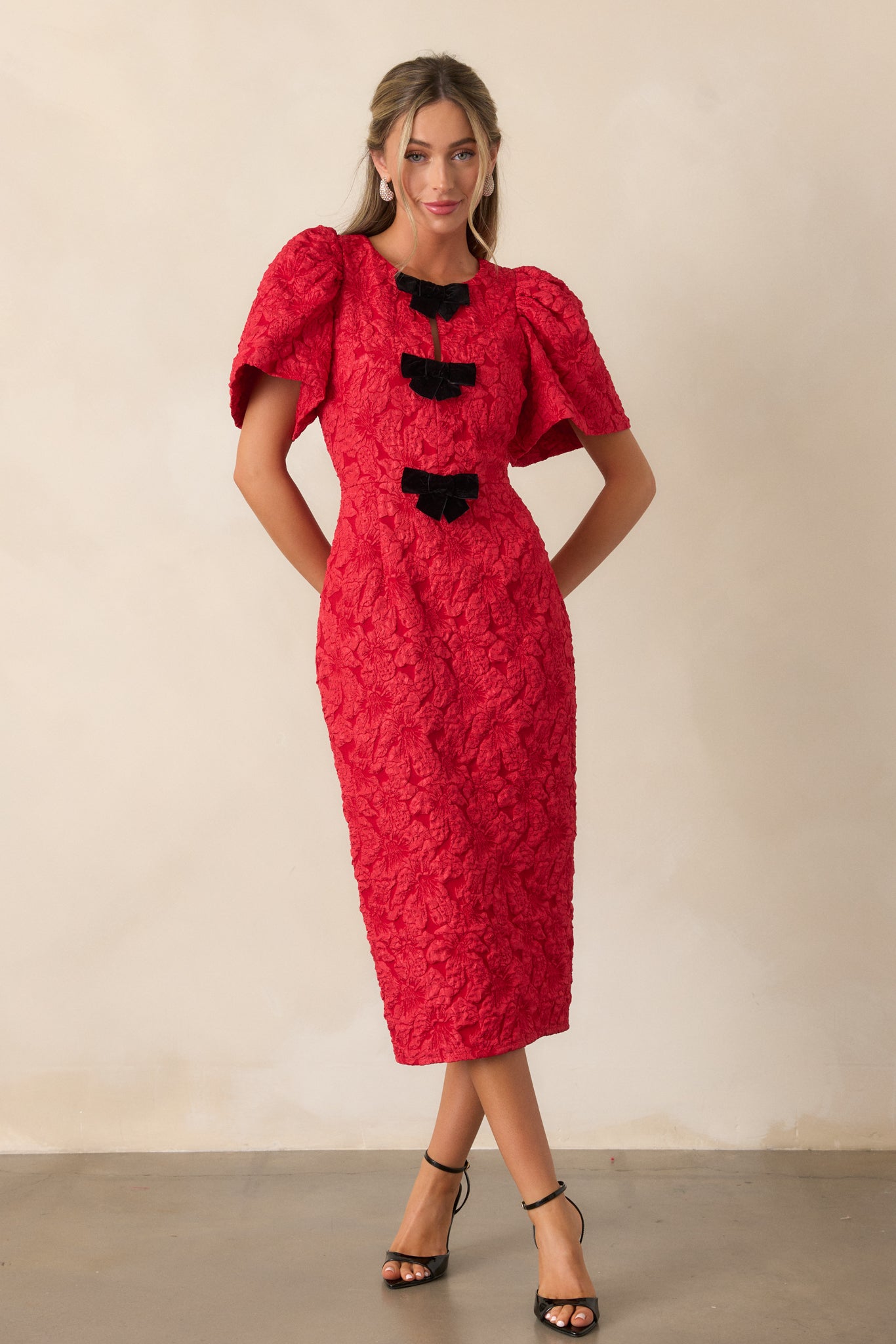 Another front view of the dress emphasizing the structured fit, subtle shimmer of the jacquard fabric, and the puff sleeve design.