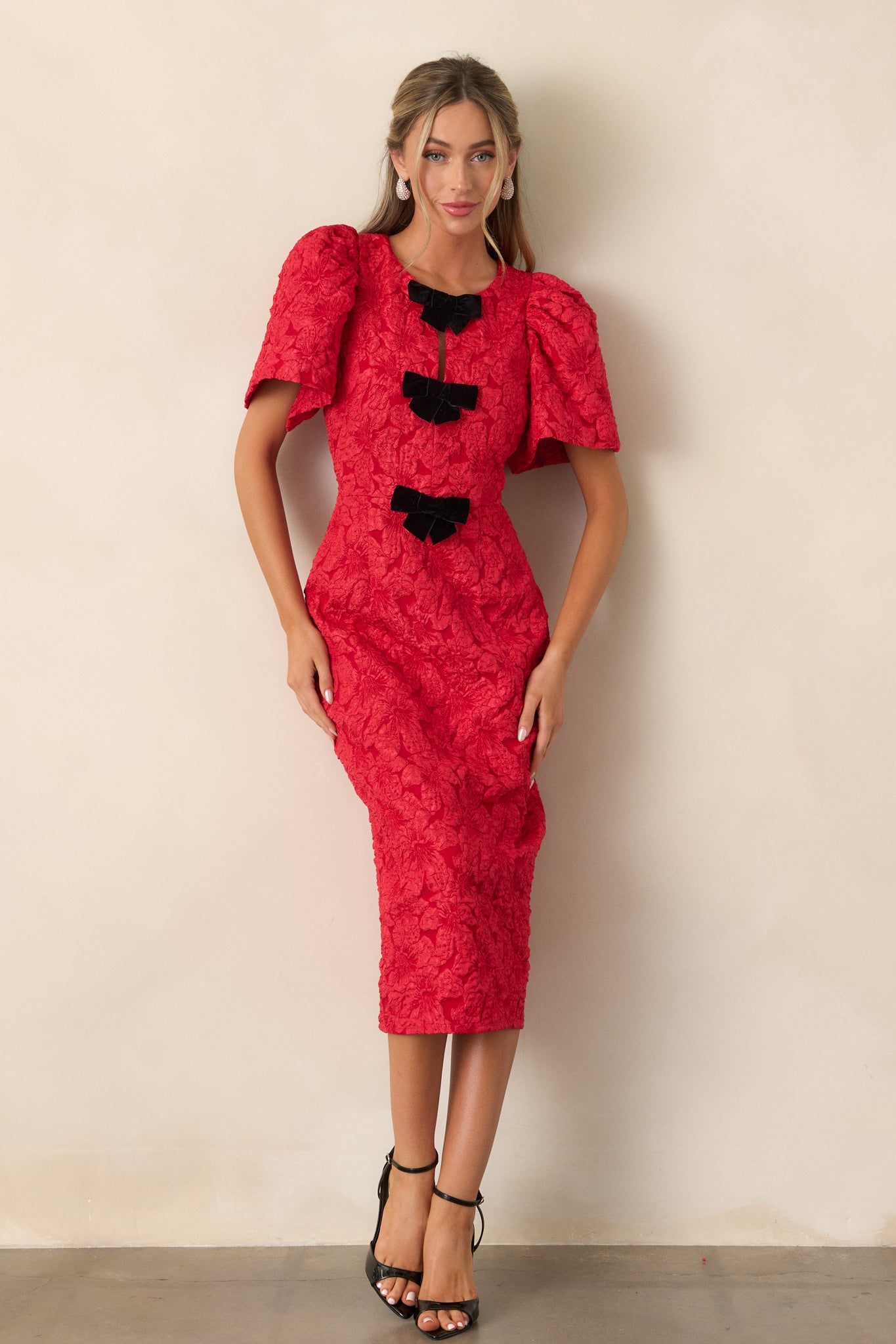 A full-length view showing the overall silhouette of the dress, the puff sleeve details, and the smooth flow of the jacquard fabric.