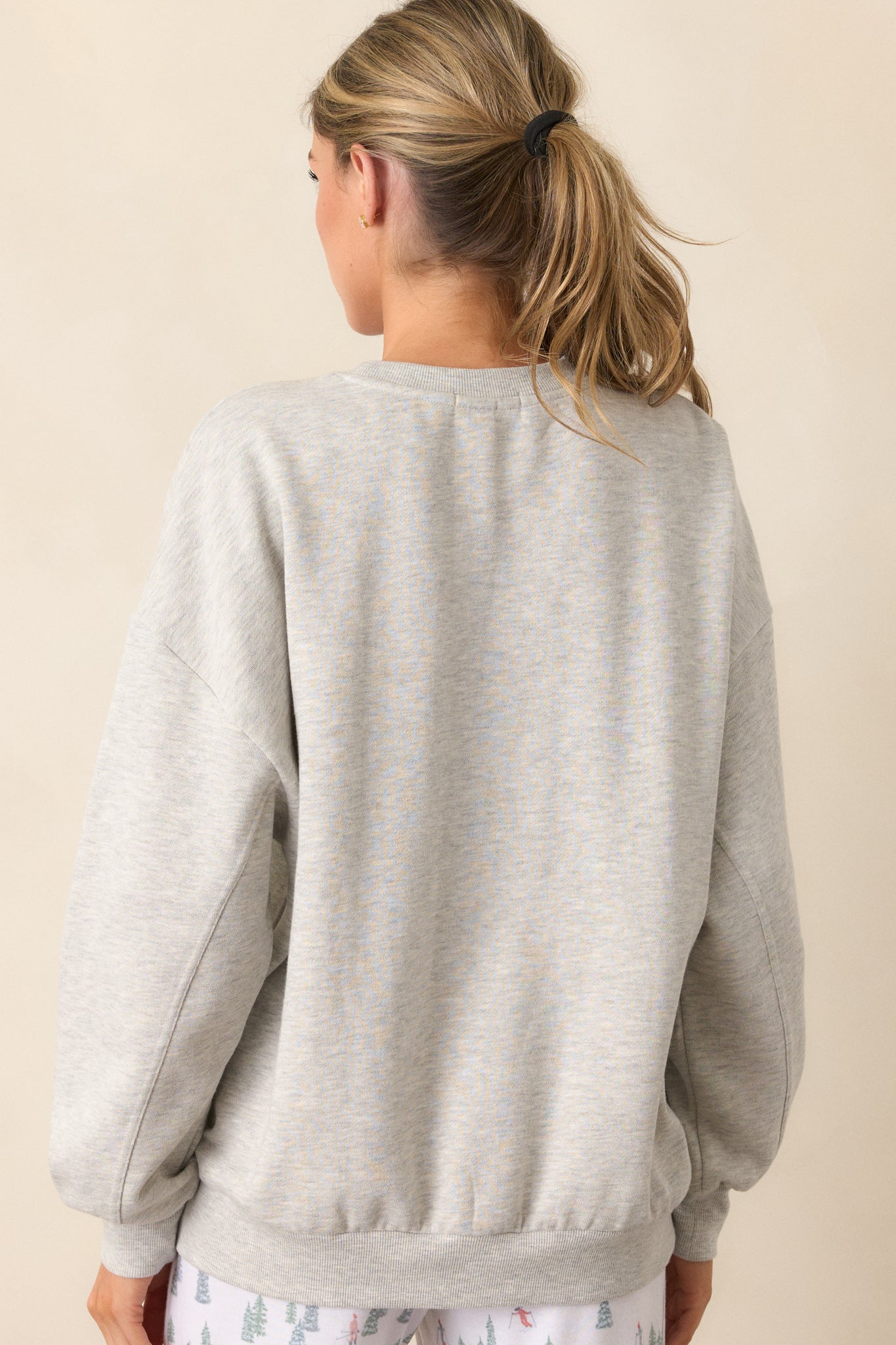 A back view of the sweatshirt, showing the relaxed fit and long sleeves with ribbed hems, offering a simple and comfortable look.