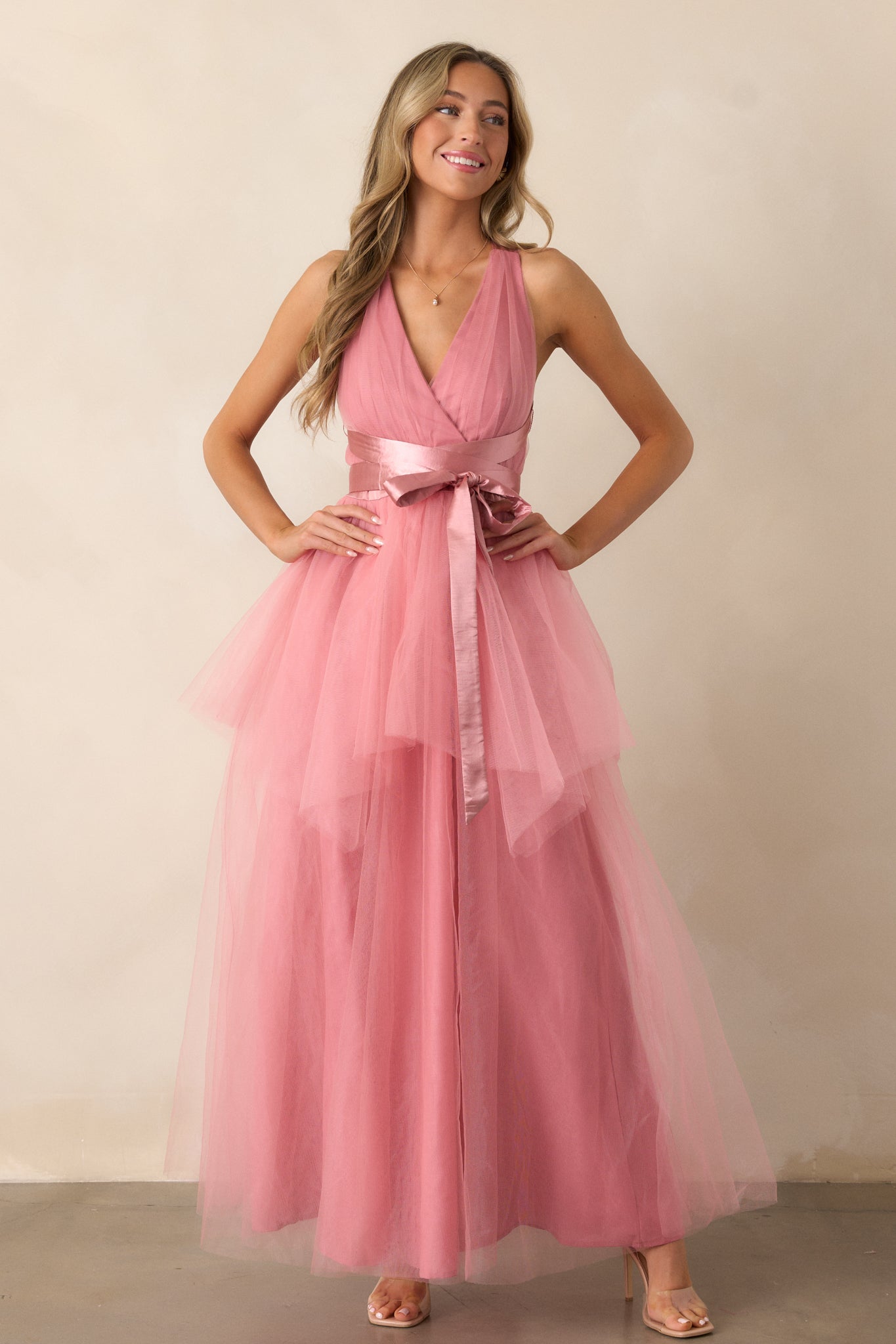 Front view of the dress emphasizing the deep V-neckline and the elegant drape of the textured layered skirt.