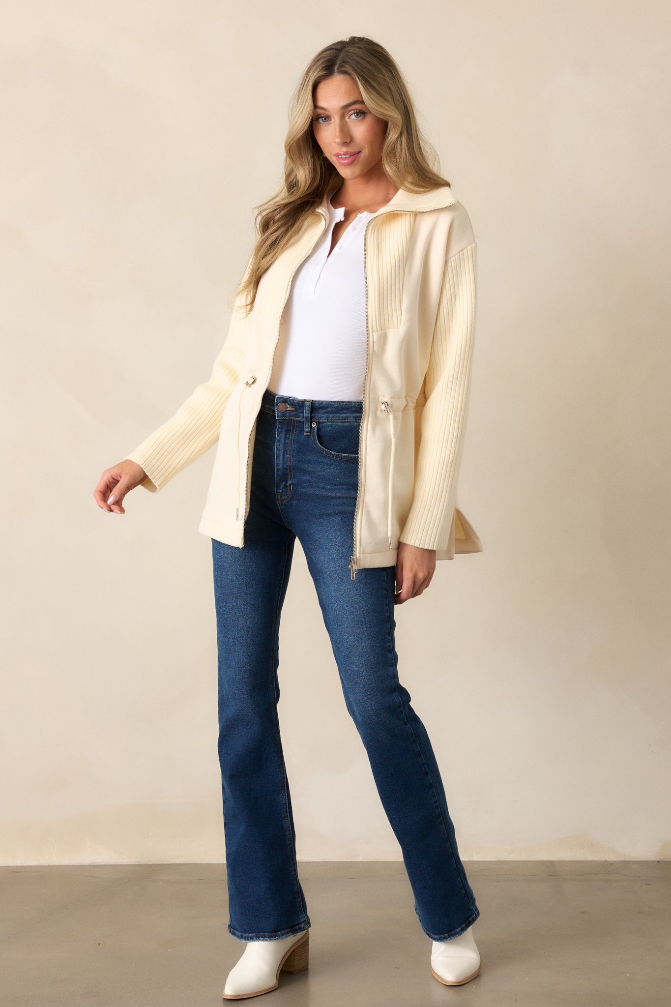 A full-length side shot highlighting the jeans' high waist, belt loops, and flared silhouette from top to bottom.