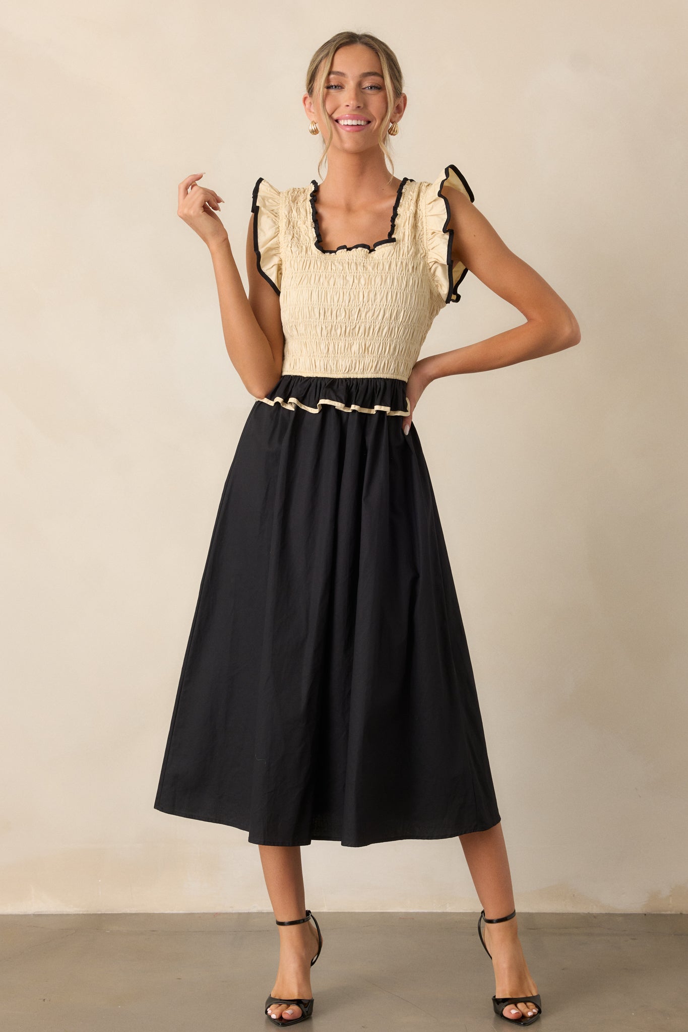 A full view of the dress featuring the smocked bodice and alternating colors that create a bold and stylish effect.