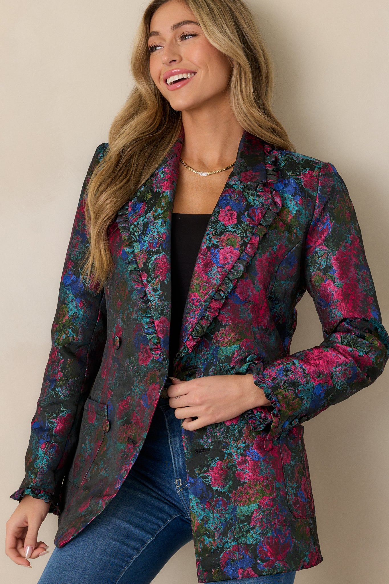 Close-up of the upper portion, focusing on the lapel collar, ruffle trim, and intricate floral pattern across the shoulders.