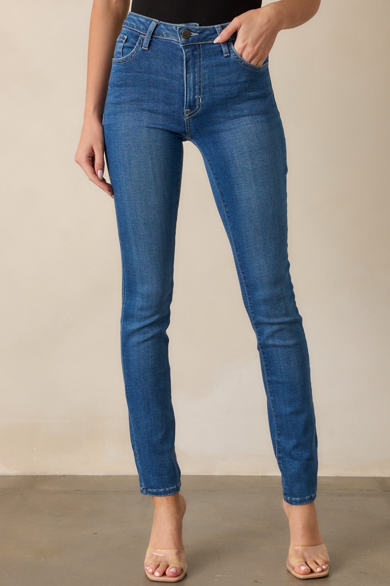 A cropped view highlighting the slim fit of the jeans along the legs, showing the tapered shape from the thighs down to the ankles. The functional pockets on both sides are visible.