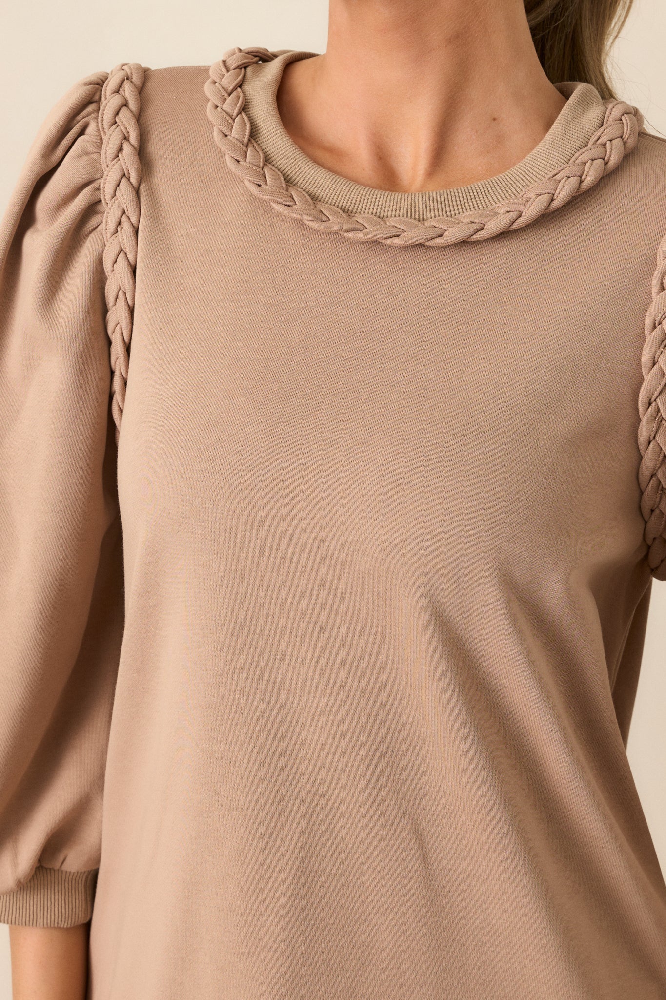 Detail shot of the braided crew neckline and braided detailing on the shoulders. 