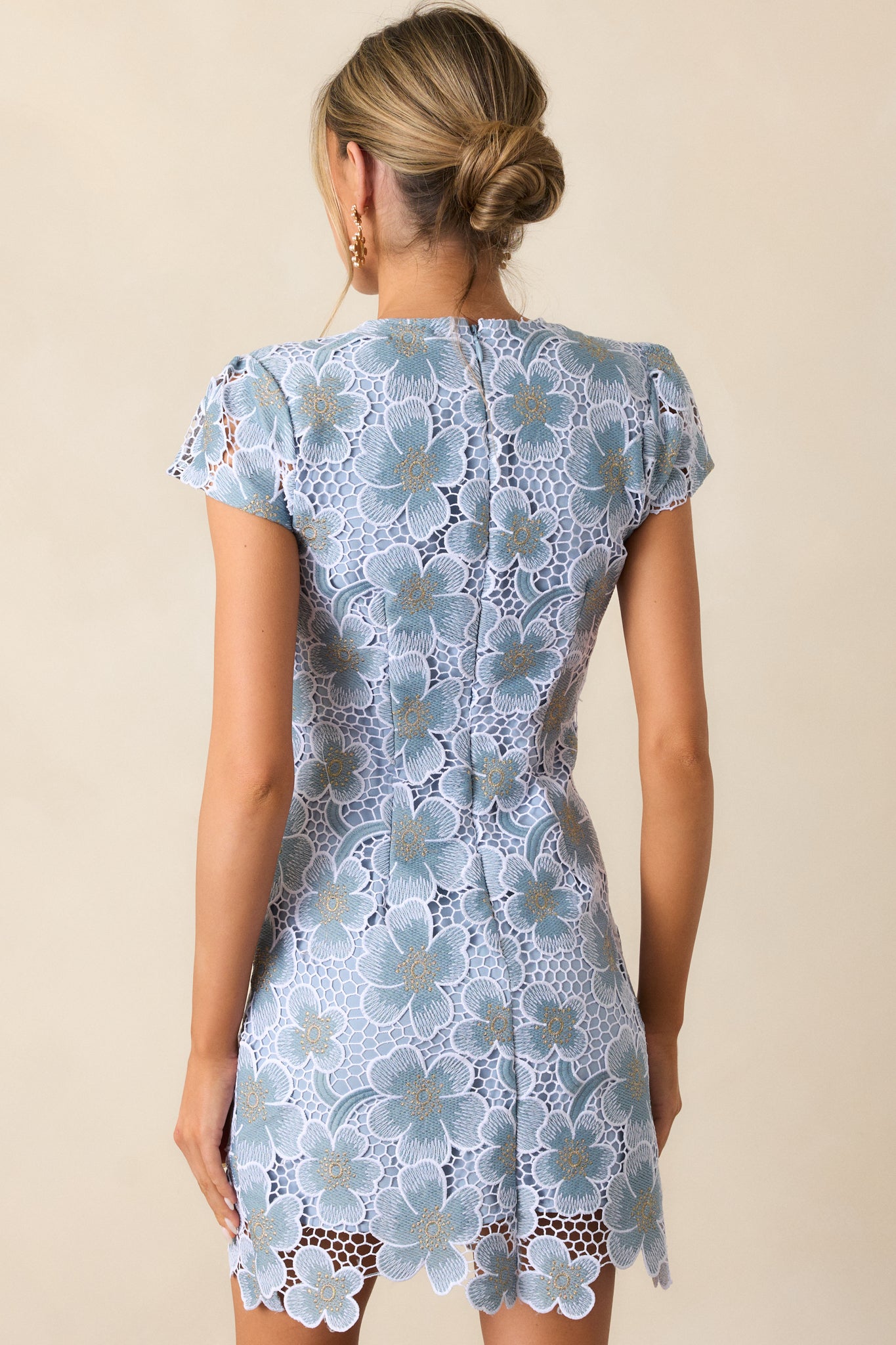 A back view of the dress, featuring a discrete zipper closure and a smooth, uninterrupted flow of the fabric.