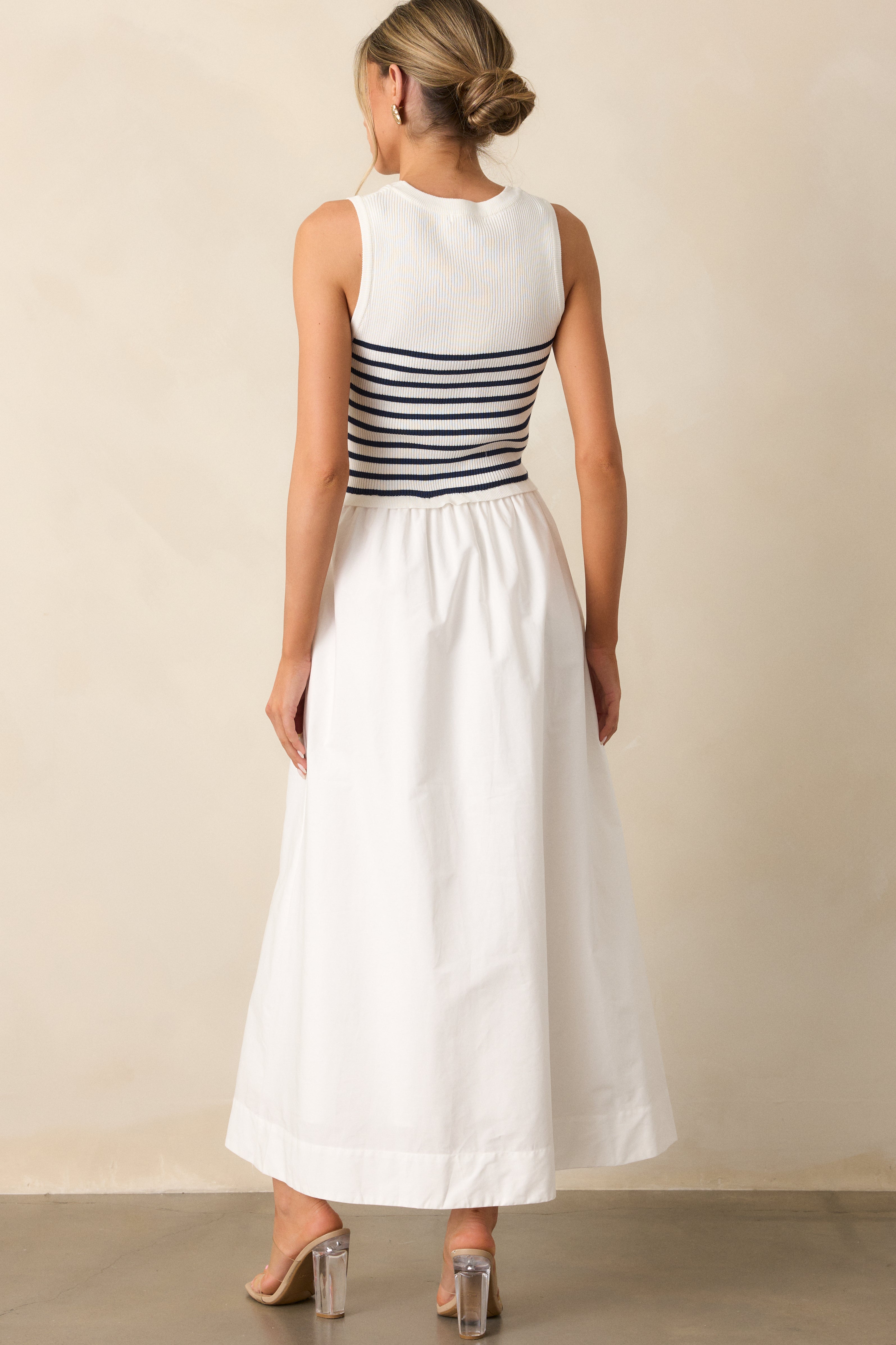 Back view of the white stripe dress showing the simple, elegant design with a smooth fit and no visible seams.