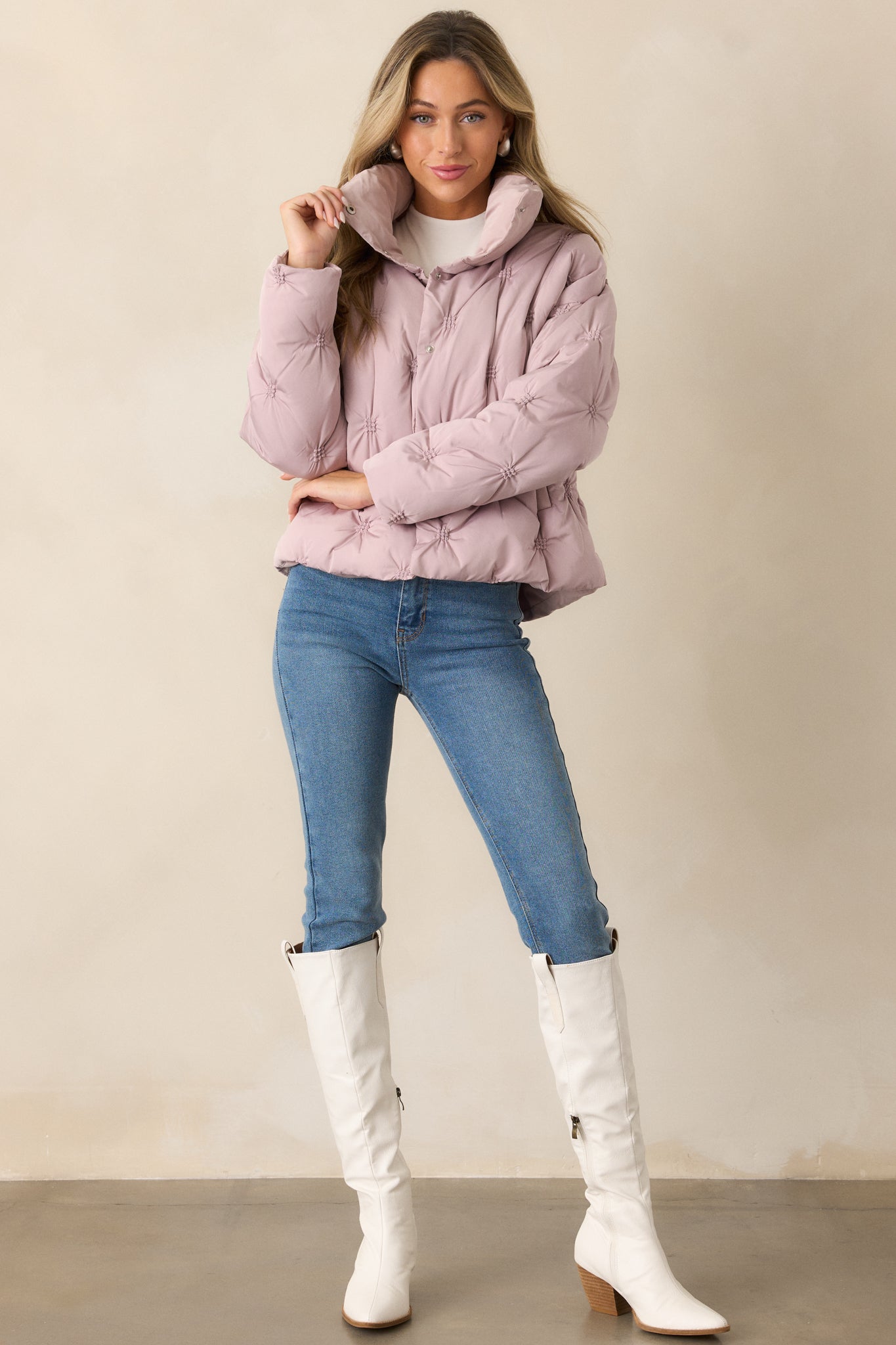 A complete full-length image of the mauve puffer jacket, highlighting its relaxed fit and tufted design.