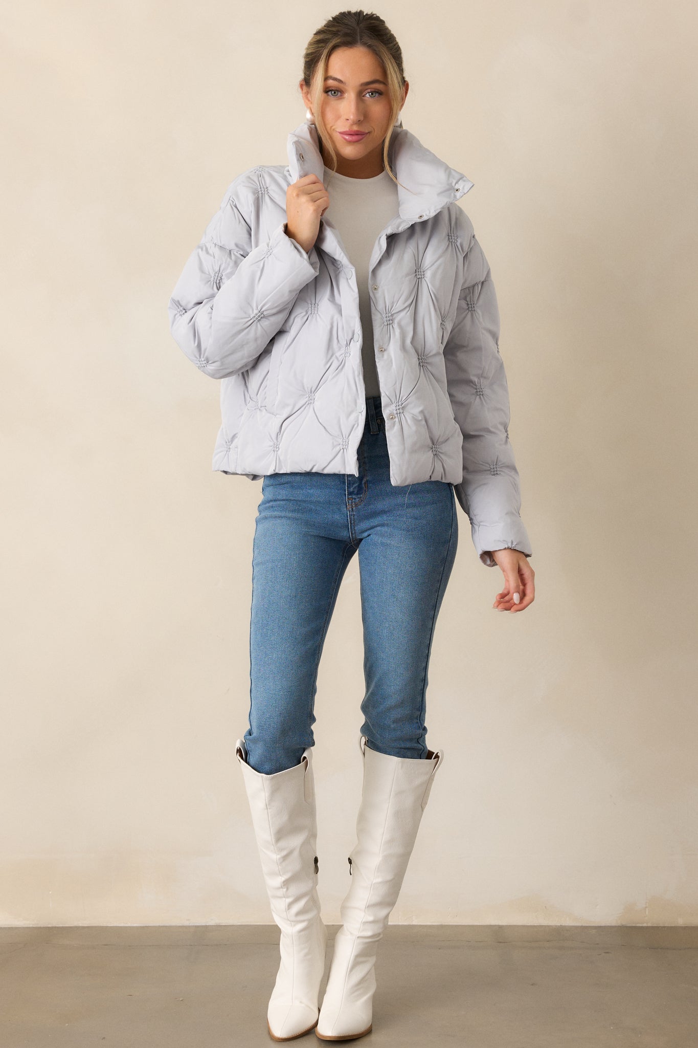 A full-length image of the ash blue jacket, highlighting its relaxed fit and tufted design.