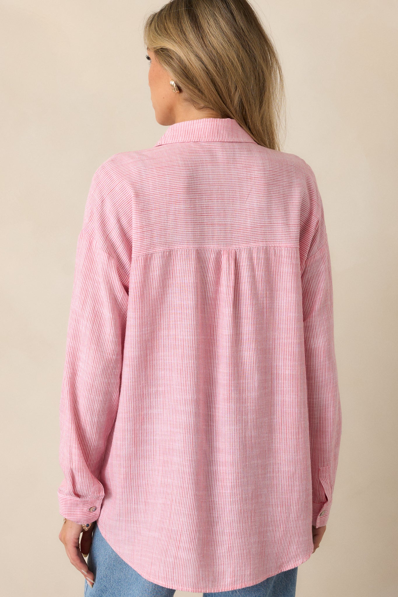 A back view of the porcelain rose blouse, focusing on the relaxed fit and long sleeves with cuffs, showing the blouse's overall length and classic, comfortable design.