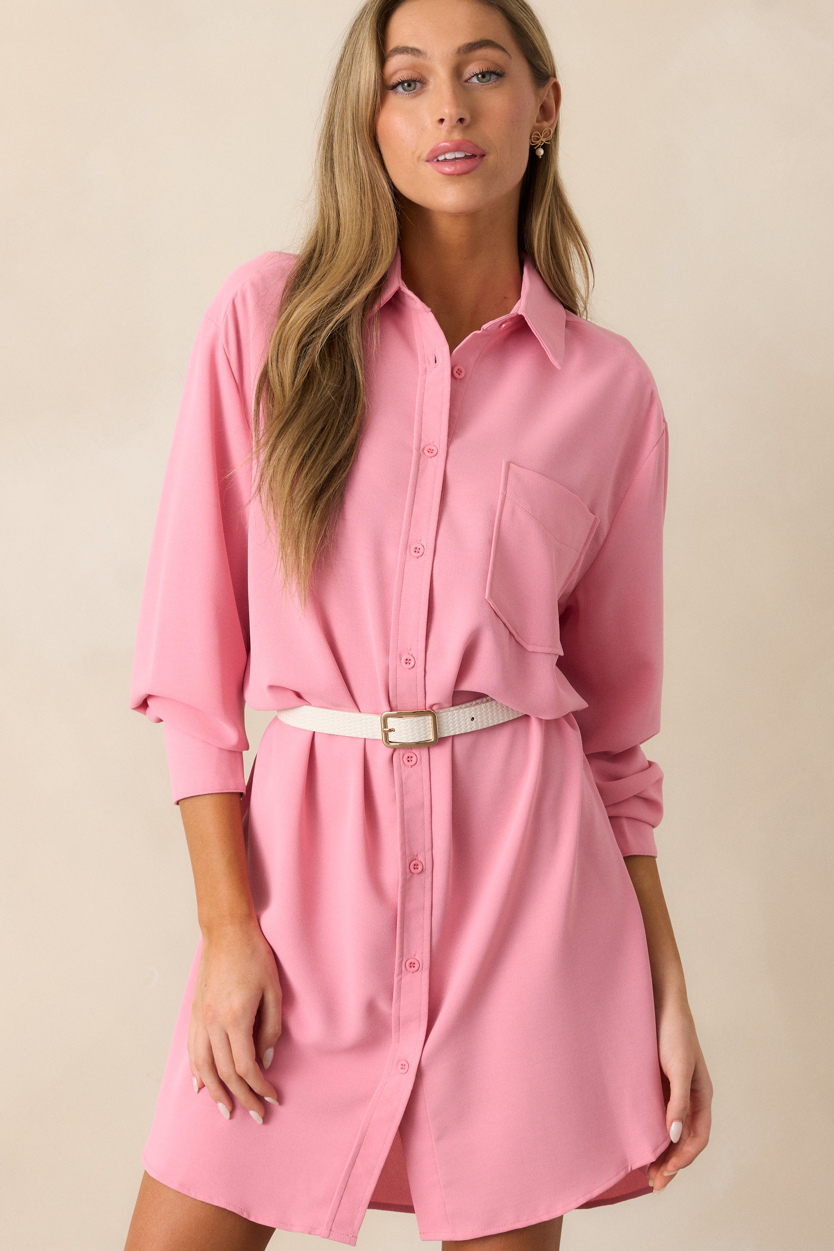 Close-up of the chest area of the pink dress, showcasing the single pocket and smooth fabric.