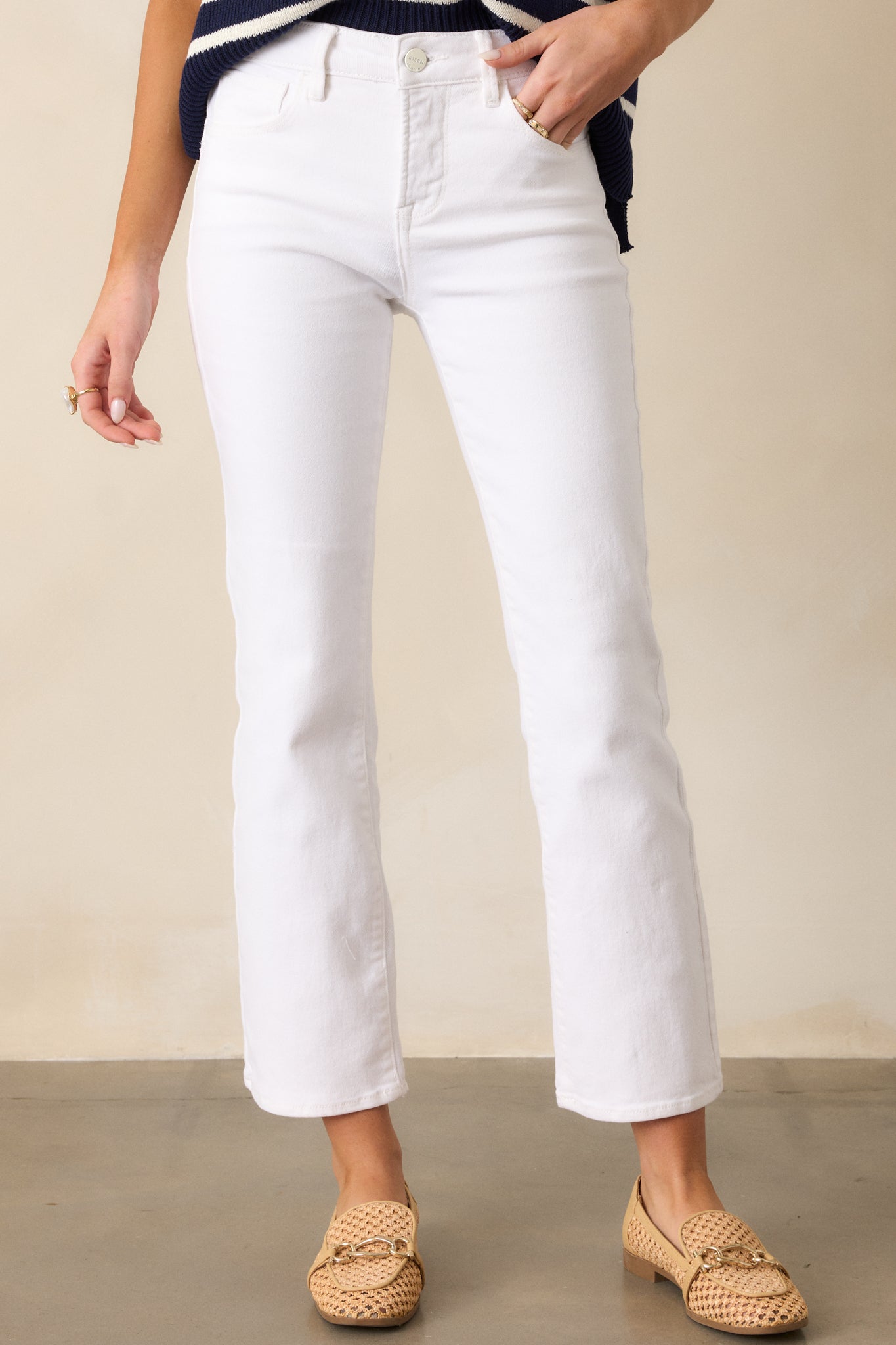 Detailed shot of the functional hip pockets and straight-leg cut, showcasing the structured fit and timeless design of these white jeans.