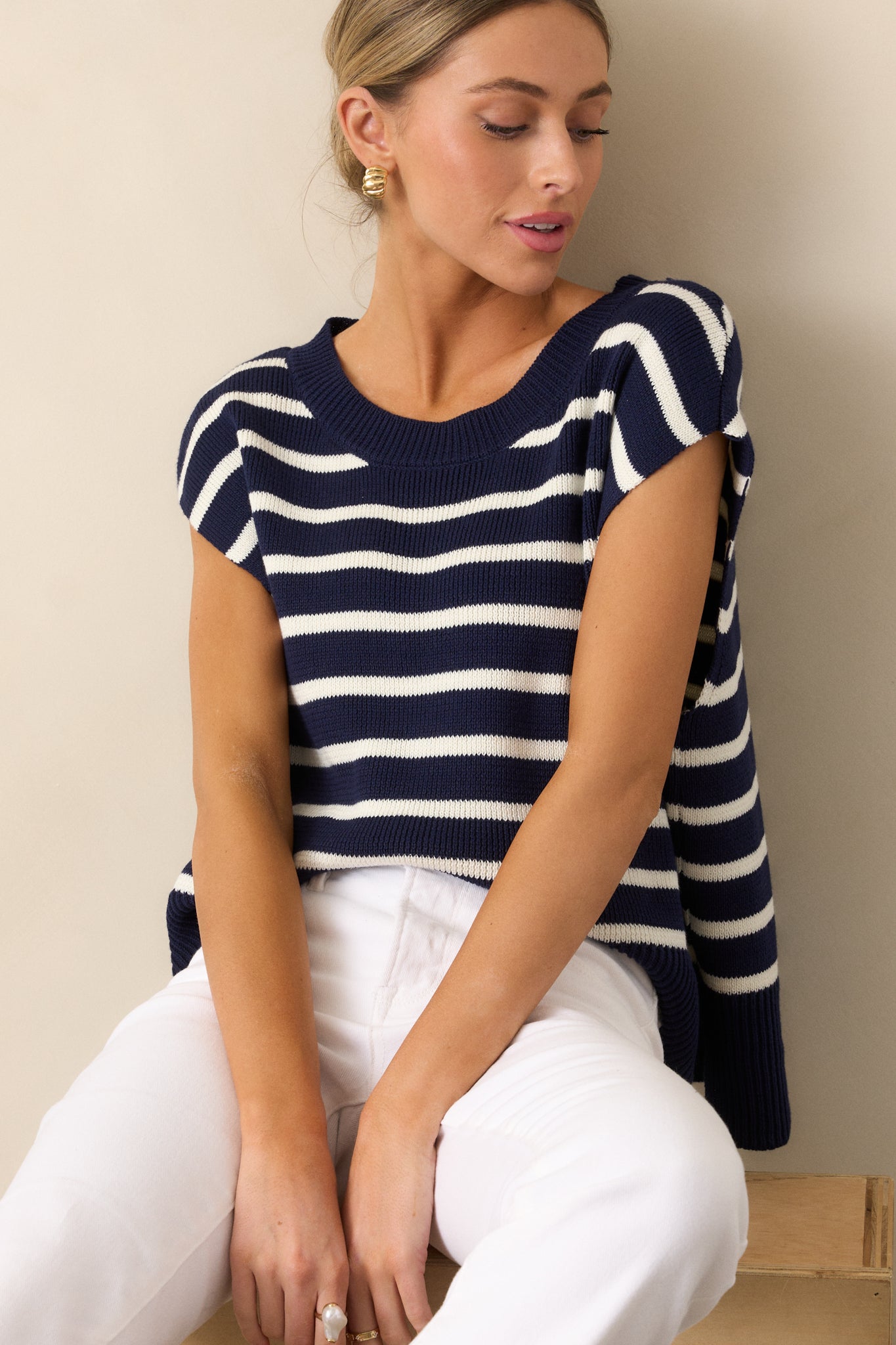  Sweater top in navy featuring a ribbed crew neckline, horizontal stripe design, short sleeves, and a subtly split ribbed hemline.