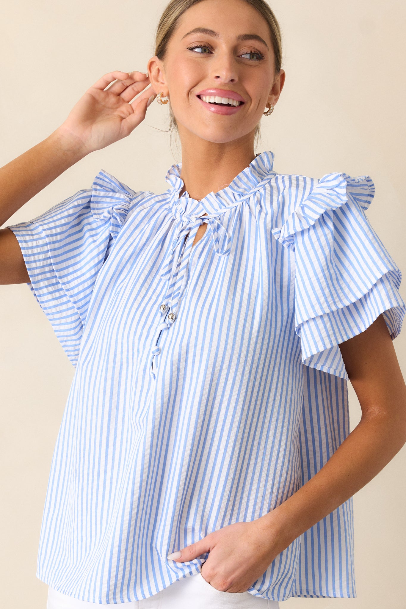 Detailed shot of the midsection of the Blue Stripe Blouse, highlighting the clean vertical blue and white stripes.