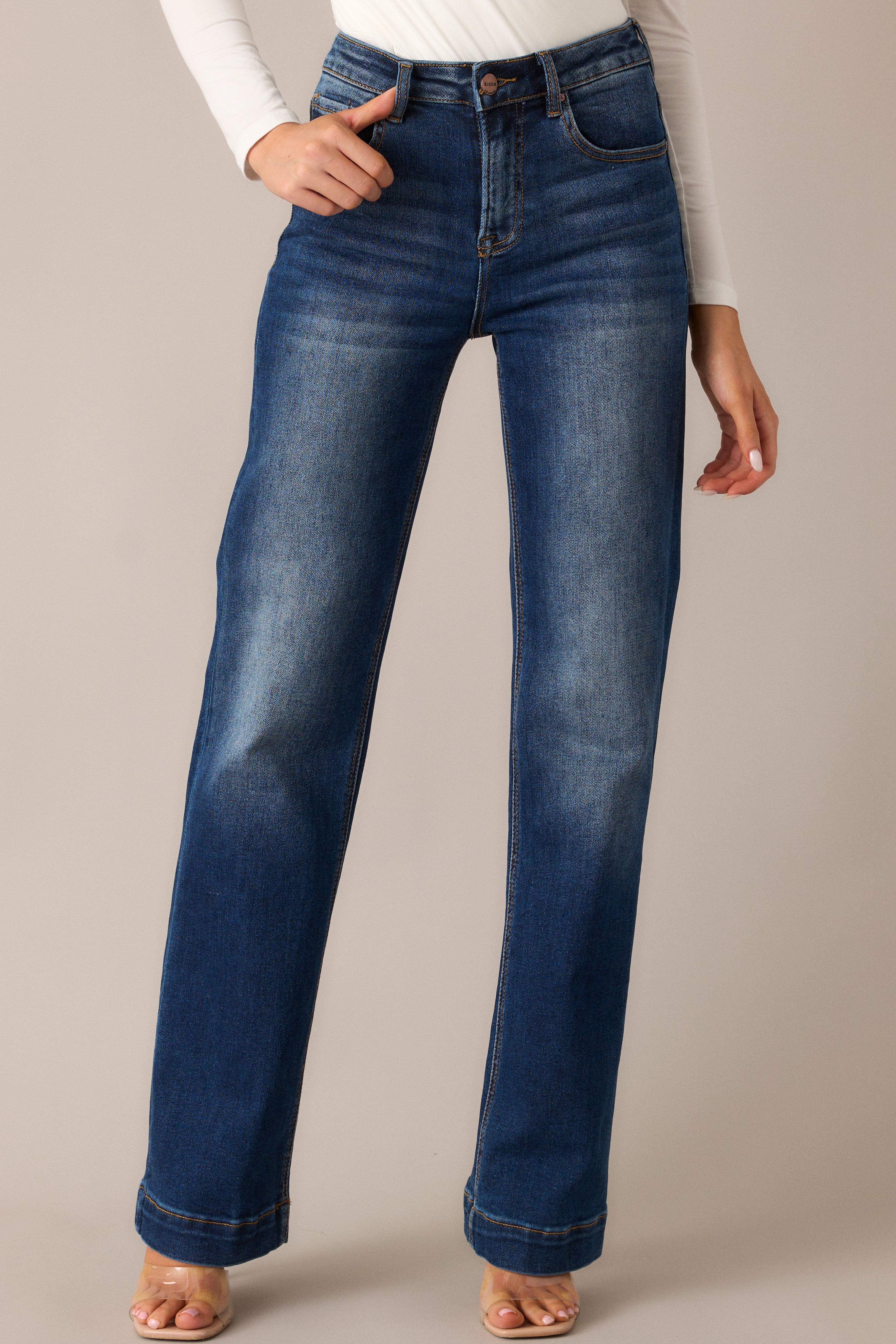 Detailed shot of the functional hip and back pockets and the high-waisted fit, with the faded thighs and knees giving these dark wash jeans a perfectly worn, effortless style.