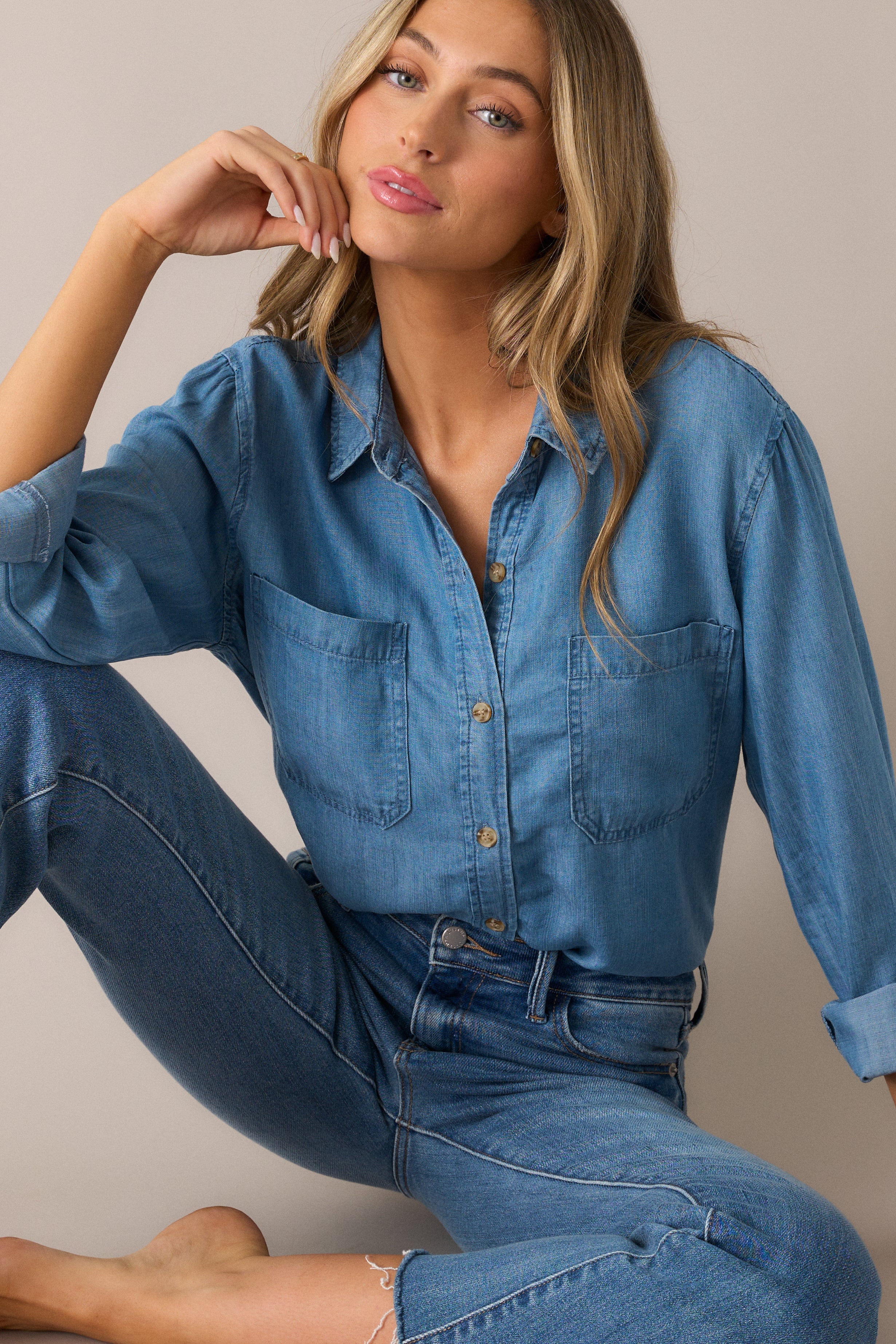 A focused shot highlighting the functional pockets and 3/4 sleeves, with button cuffs adding a polished touch to the blouse’s effortless style.