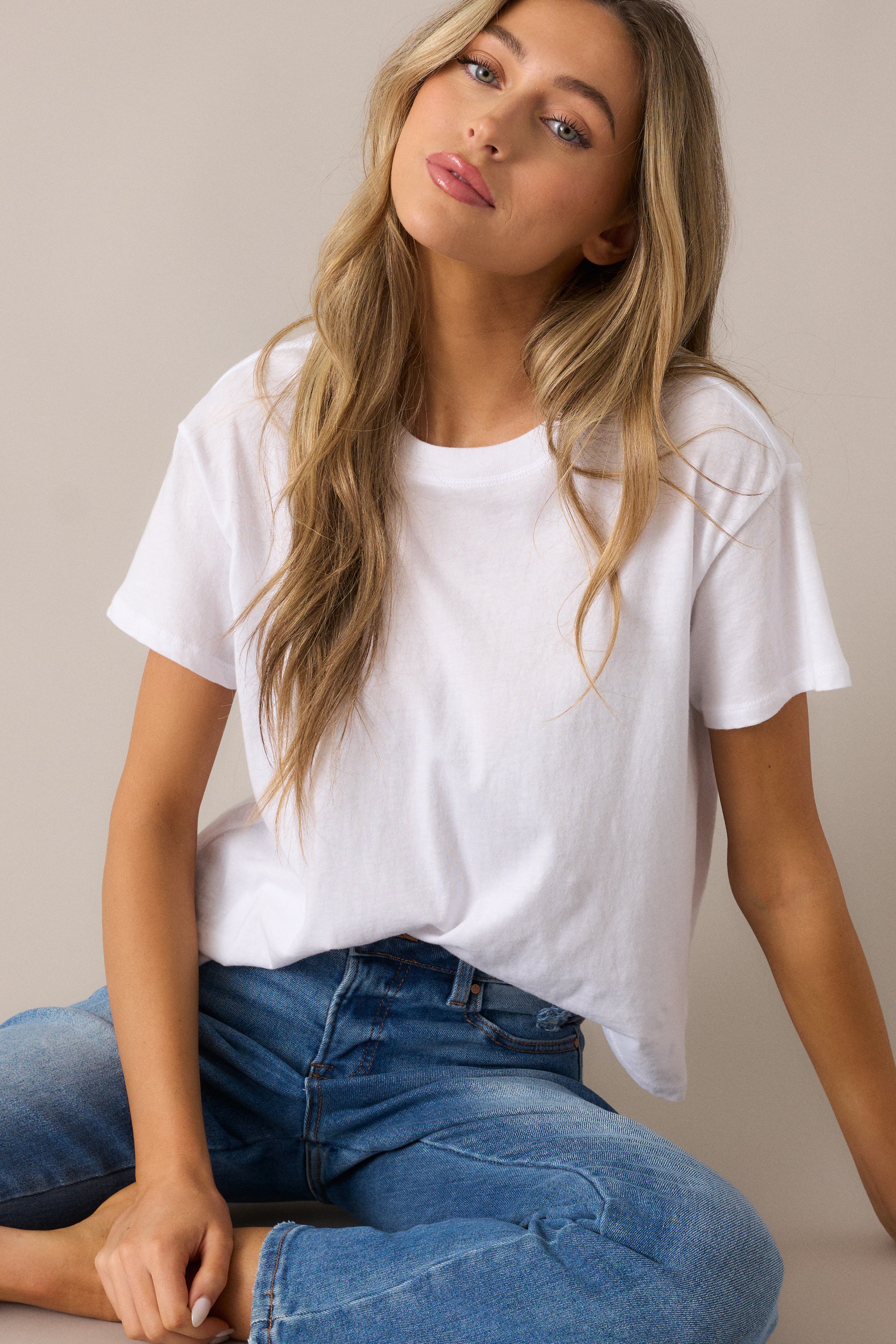 Soft and versatile tee with a ribbed crew neckline, relaxed silhouette, and short sleeves, making it the ideal piece for a casual-chic ensemble.