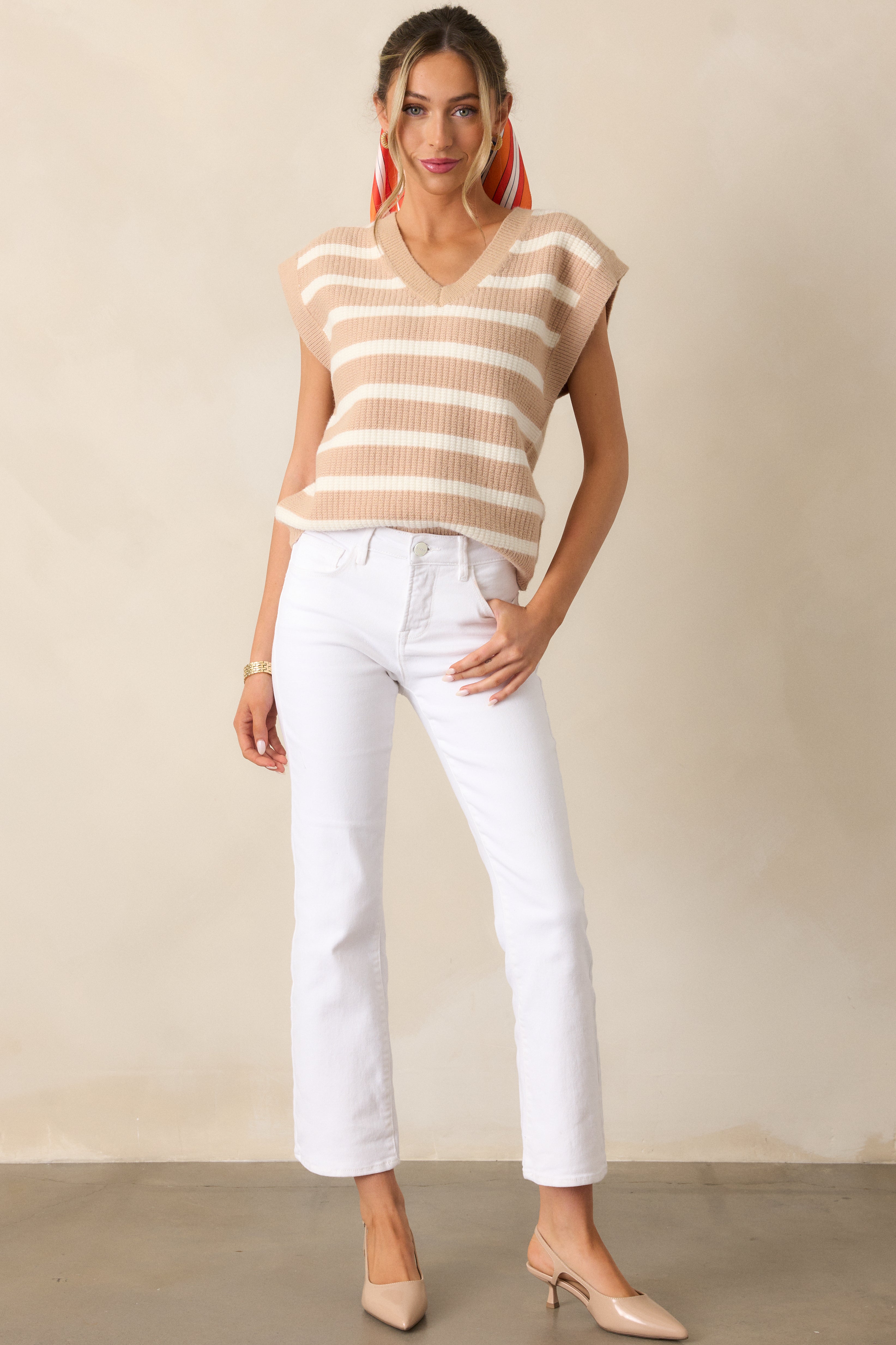 Tan sweater with a breezy, relaxed fit, showcasing a V-neck and fresh white stripes, complete with cap sleeves for that carefree vibe.