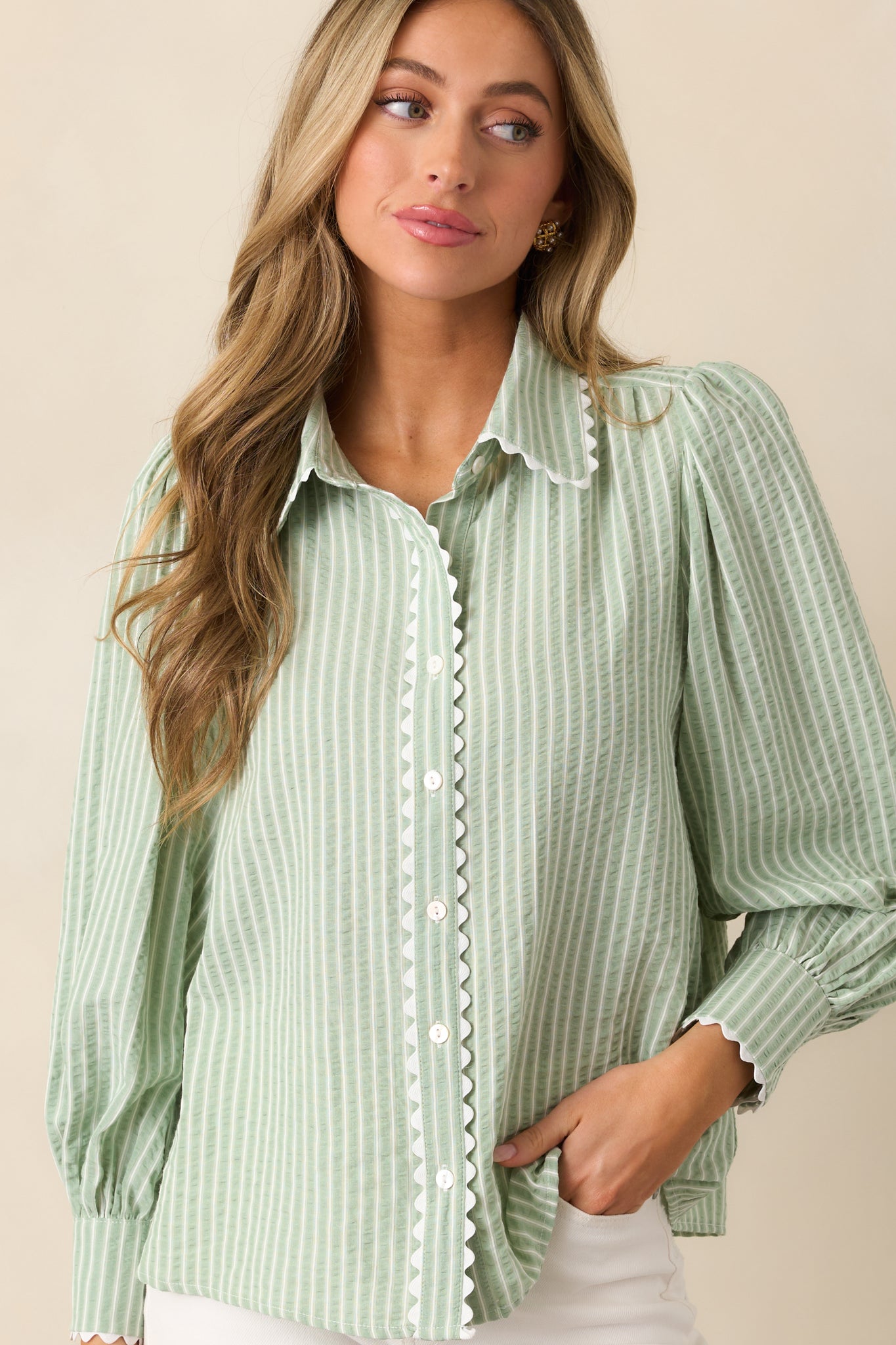 The ricrac trim offers a unique touch, accentuating the soft stripe print of this blouse.