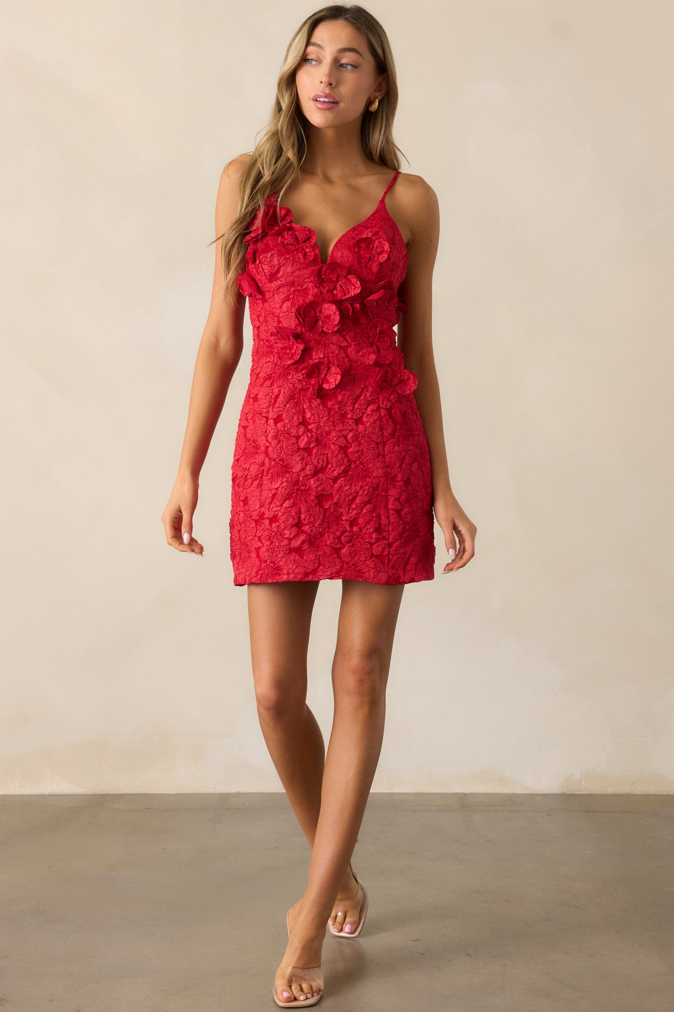 Straight front view of the red mini dress, emphasizing the floral appliques and the flattering silhouette.