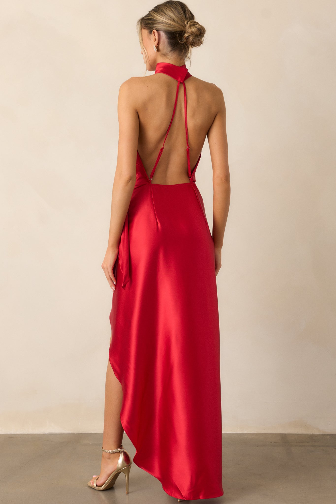 Back view of the red dress, showcasing the adjustable straps, halter neckline, and the smooth back design.