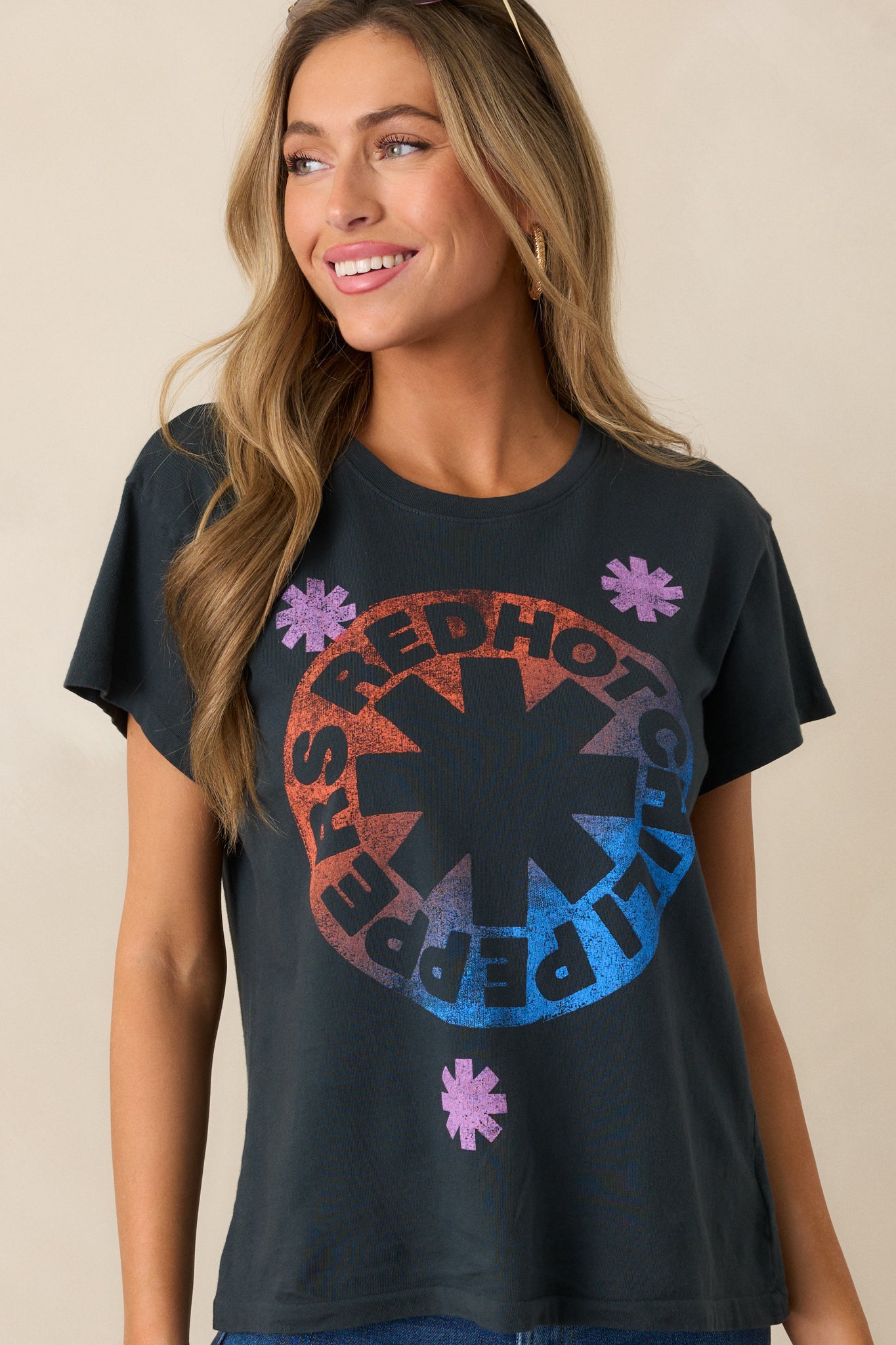 Cropped image emphasizing the tee's neckline and short sleeve cut, along with part of the colorful graphic design.