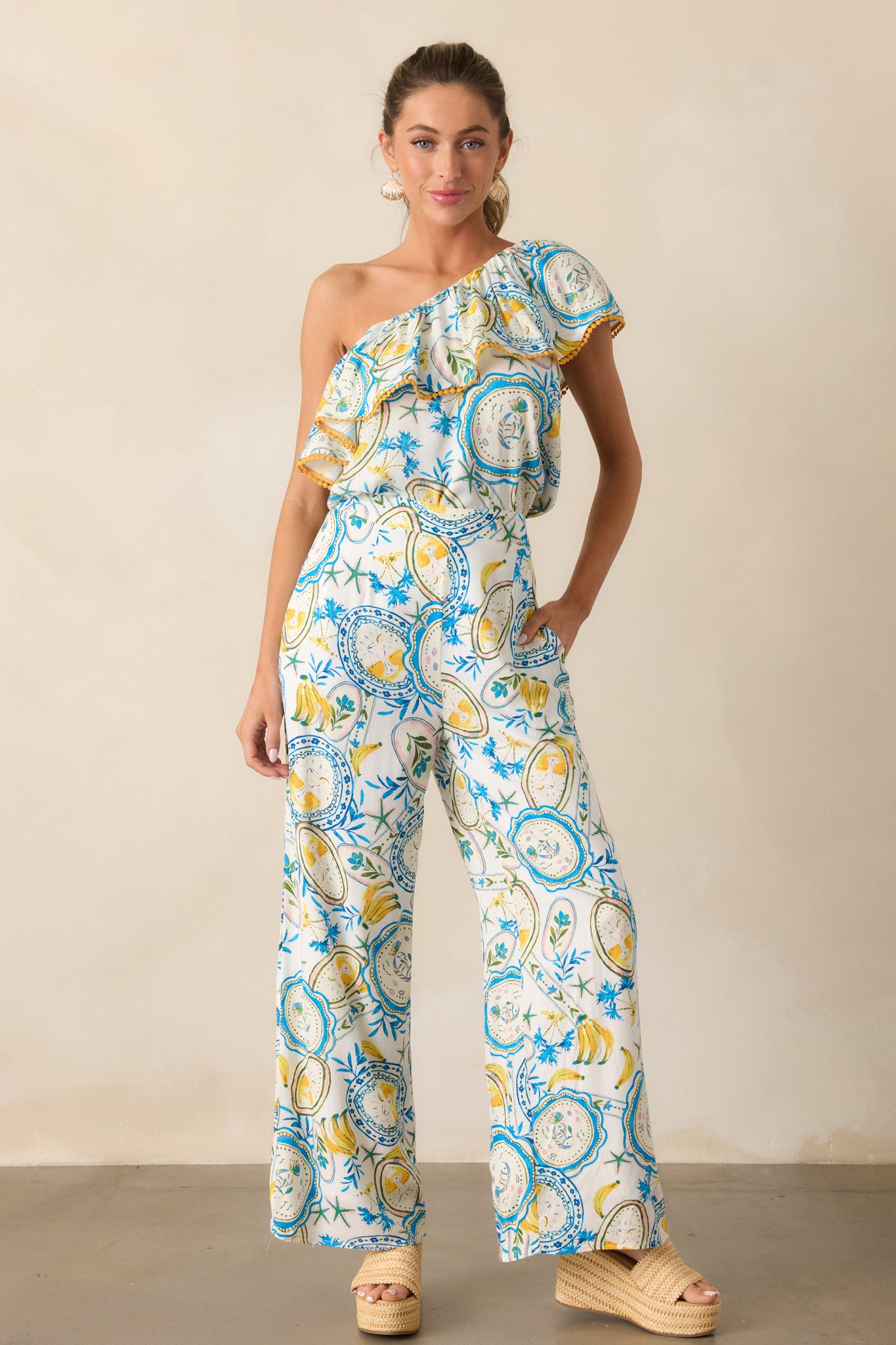 The ivory pants in a full-length shot, featuring a beautiful tropical print and wide leg design.