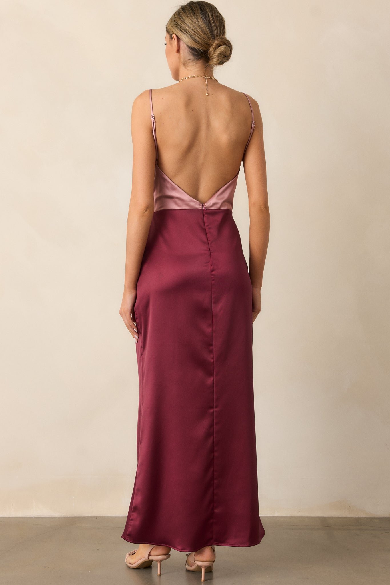 The back view of the mauve mist dress, showcasing its low open back, slim adjustable straps, and the hidden zipper for a sleek finish.