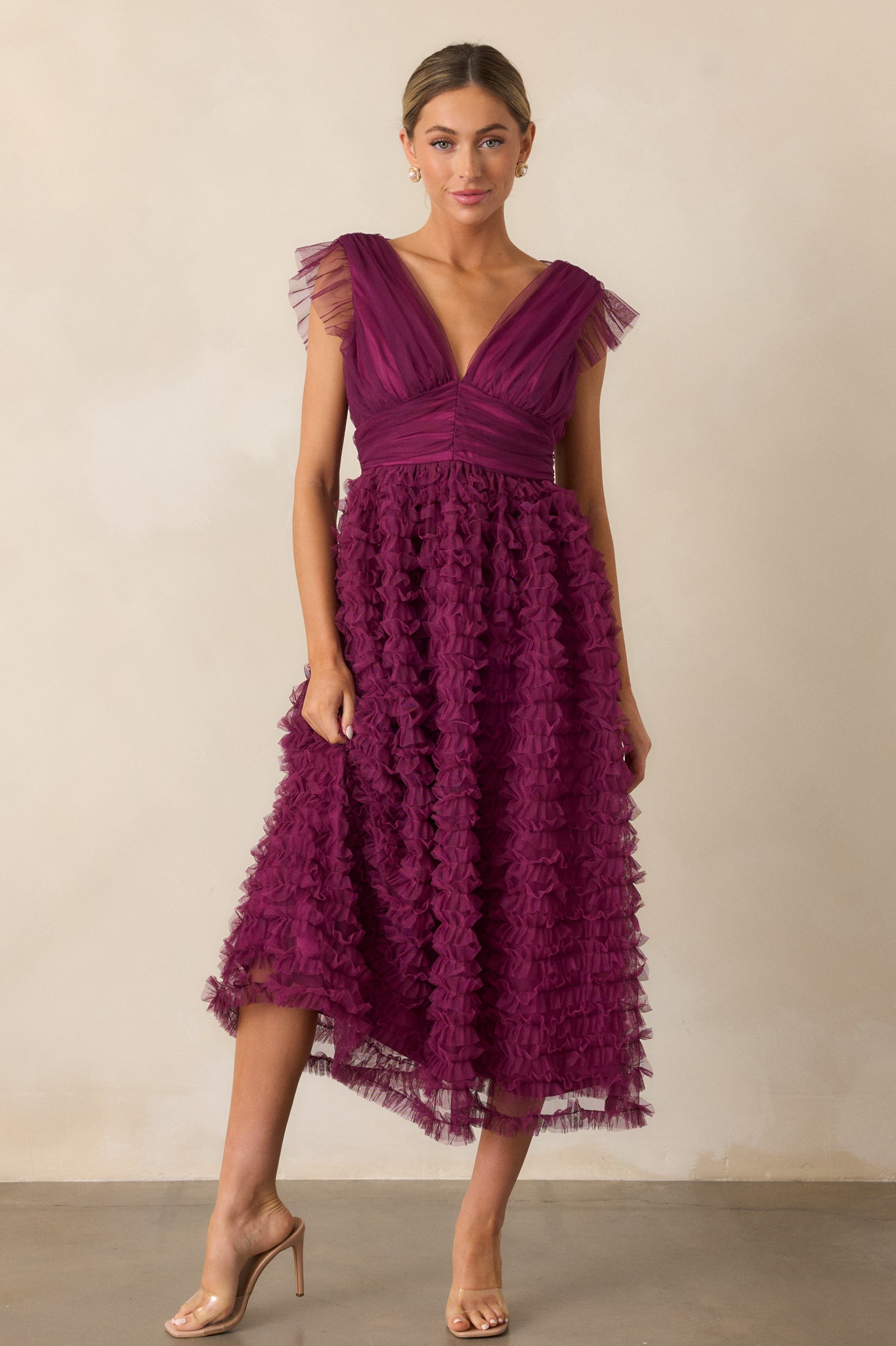 A full-length image of the plum midi dress, showcasing its v-neckline, ruffle-stitched skirt, and cinched waistband detailing.