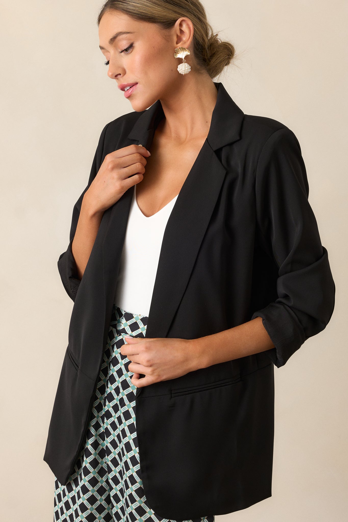 Close-up cropped view emphasizing the blazer's collared neckline and clean, structured shoulders.