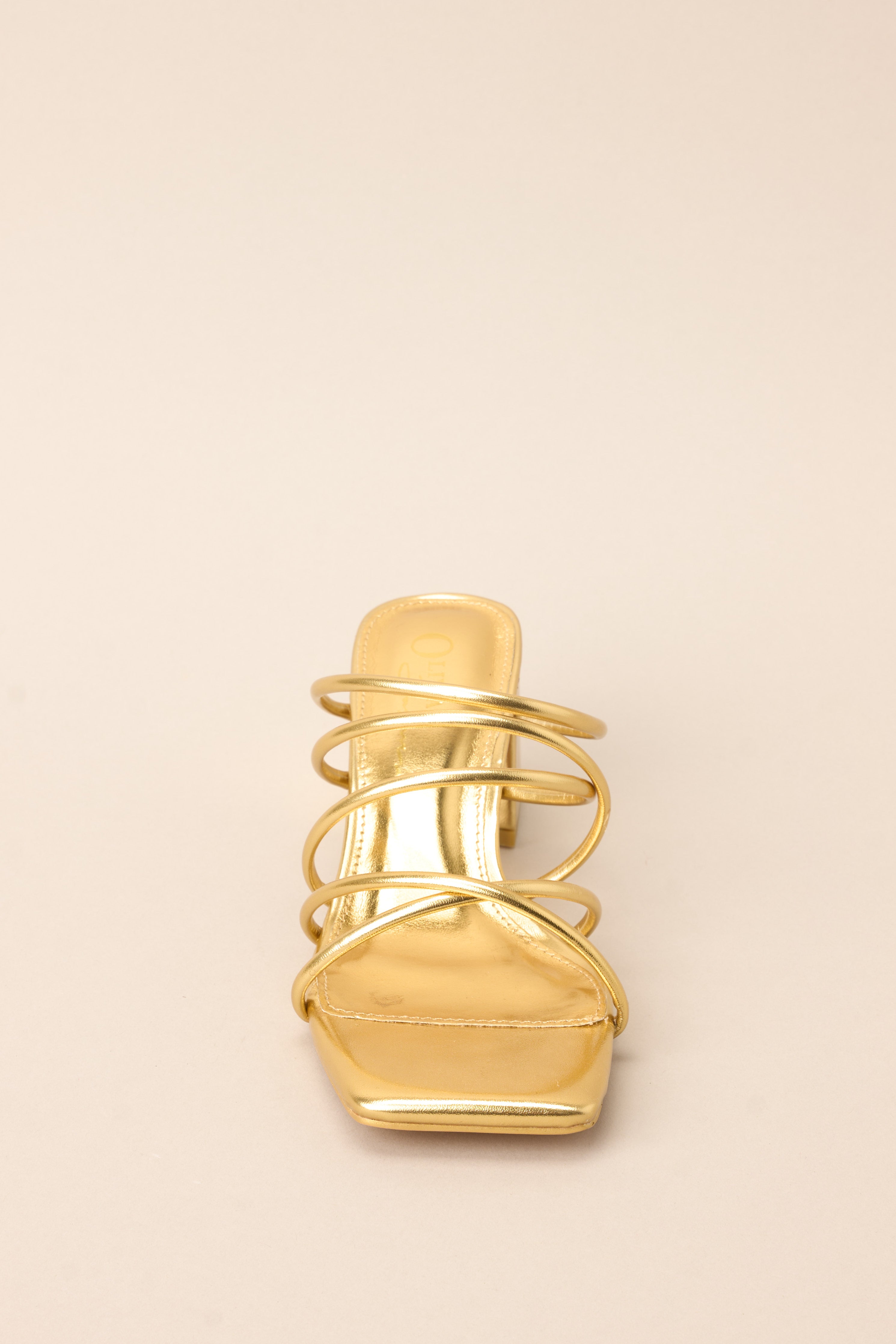 Front view of these heels that feature a rounded toe, a slip-on design crisscross straps across the top of the foot, and a short, thick heel.