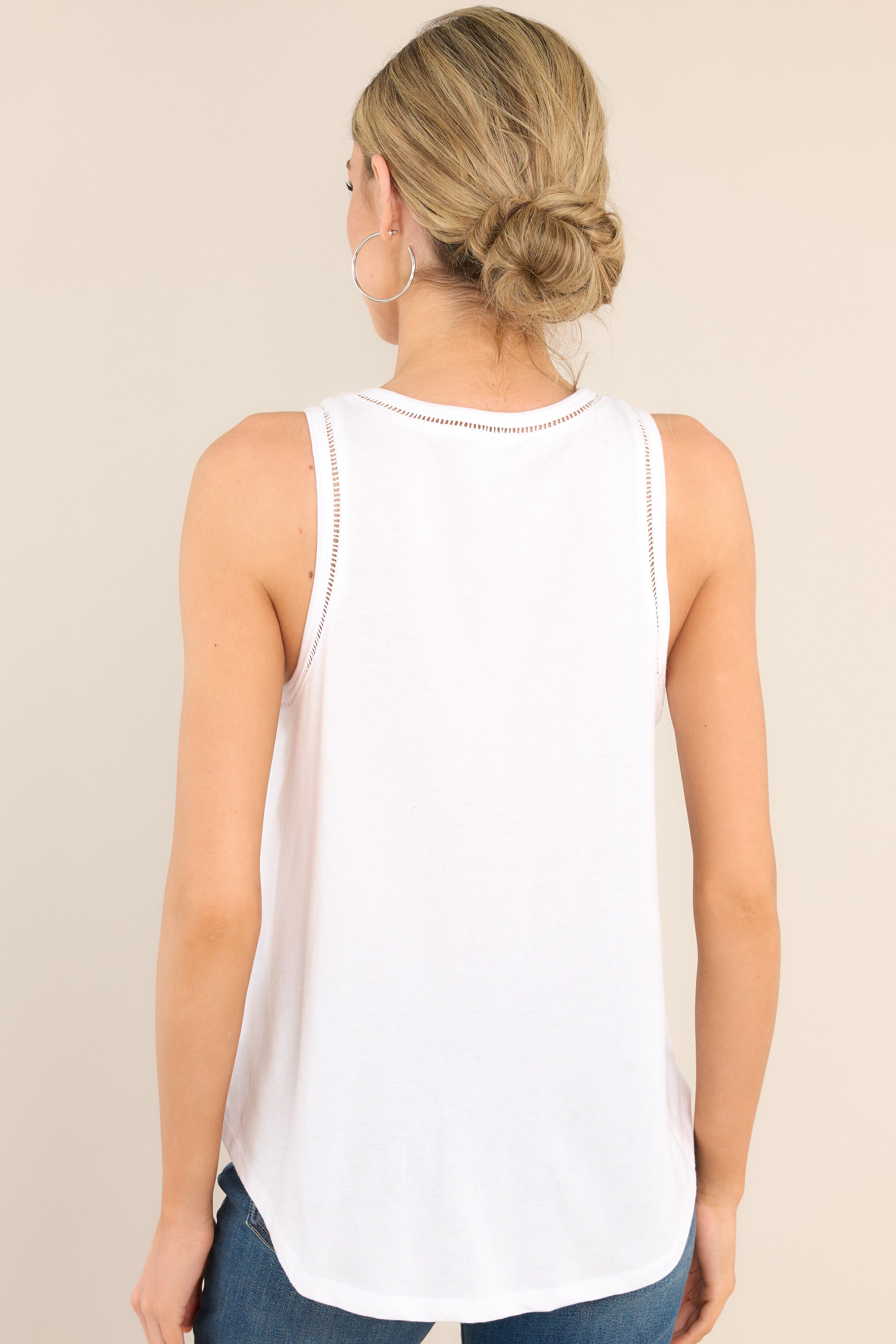 Back view of  this top that features a v-neckline, lace trim around the neckline and sleeves, a scooped hem, and a buttery-soft feel.