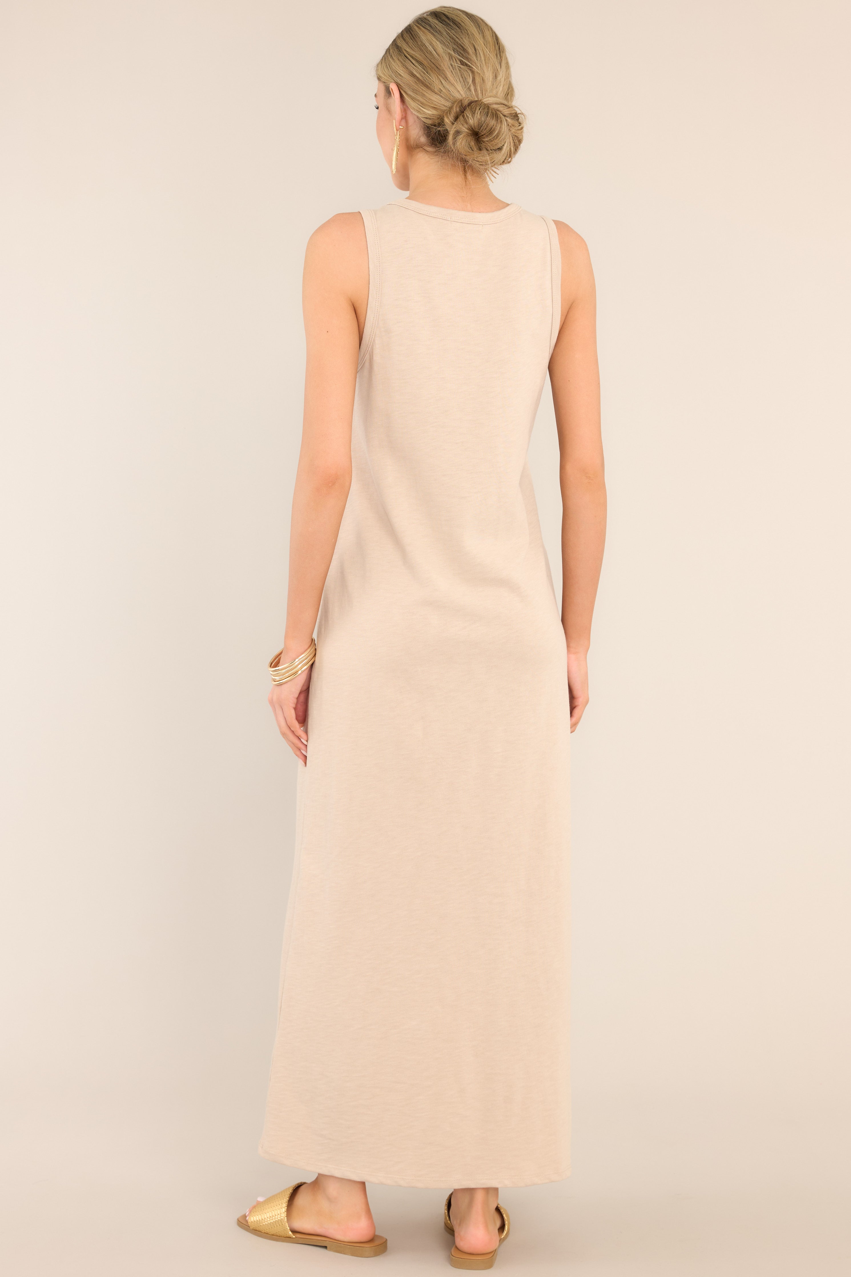 Back view of  this dress that features a crew neckline, a straight silhouette, and a slightly stretchy cotton material that gives it a relaxed fit.