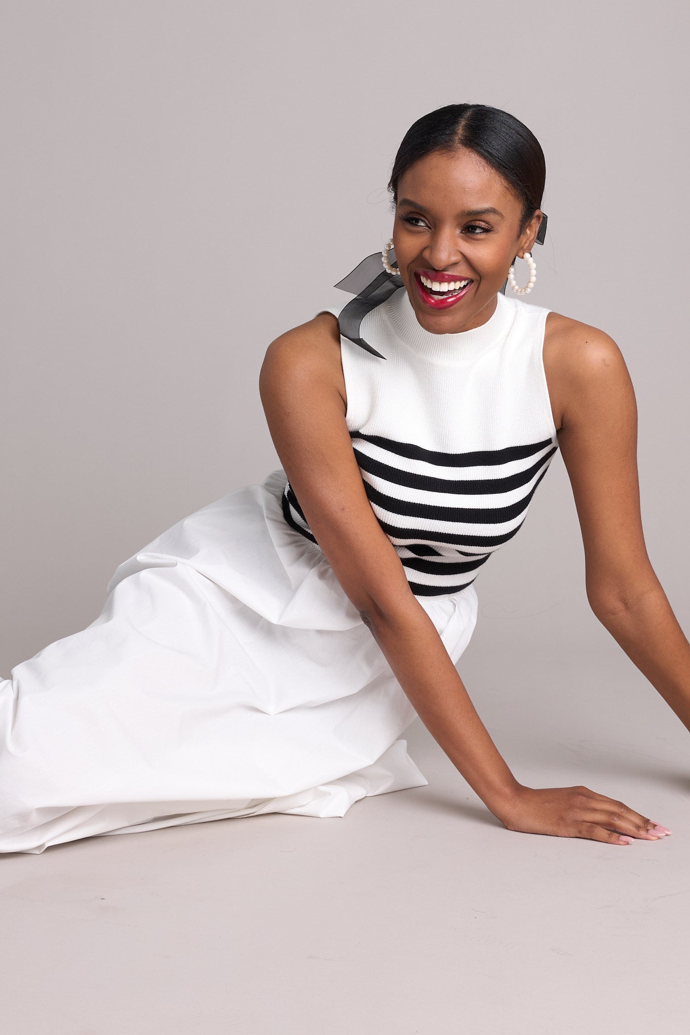 Relaxed close-up view of Black &amp; White Sleeveless Striped Maxi Dress.&nbsp;