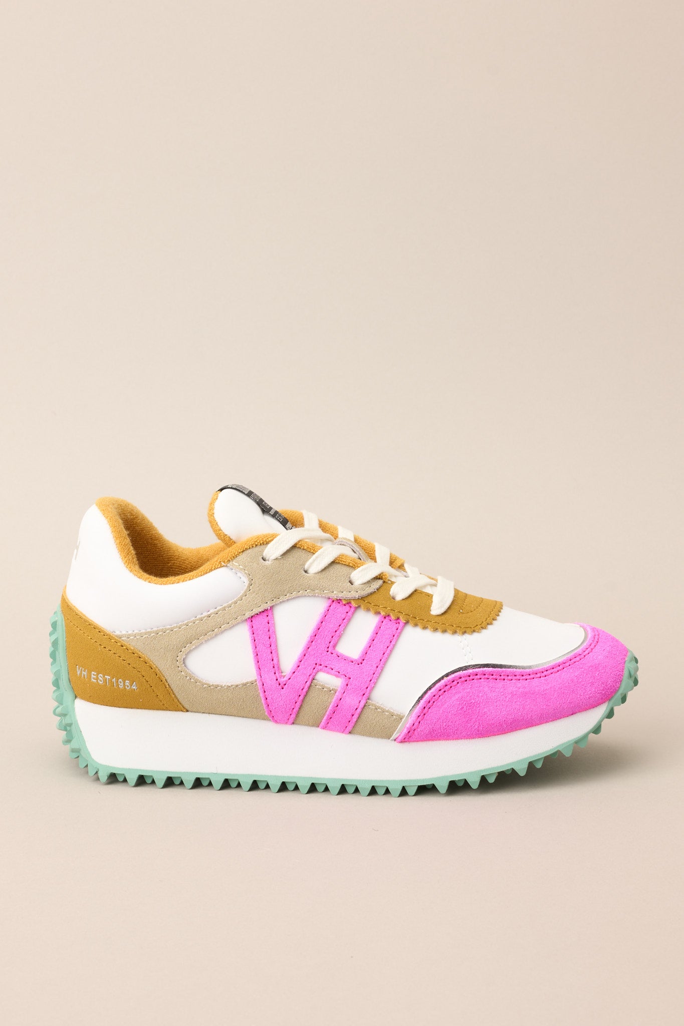 Outer-side view of these sneakers that feature a rounded toe, functional laces, pops of color, a slight platform, and a heavily textured sole.