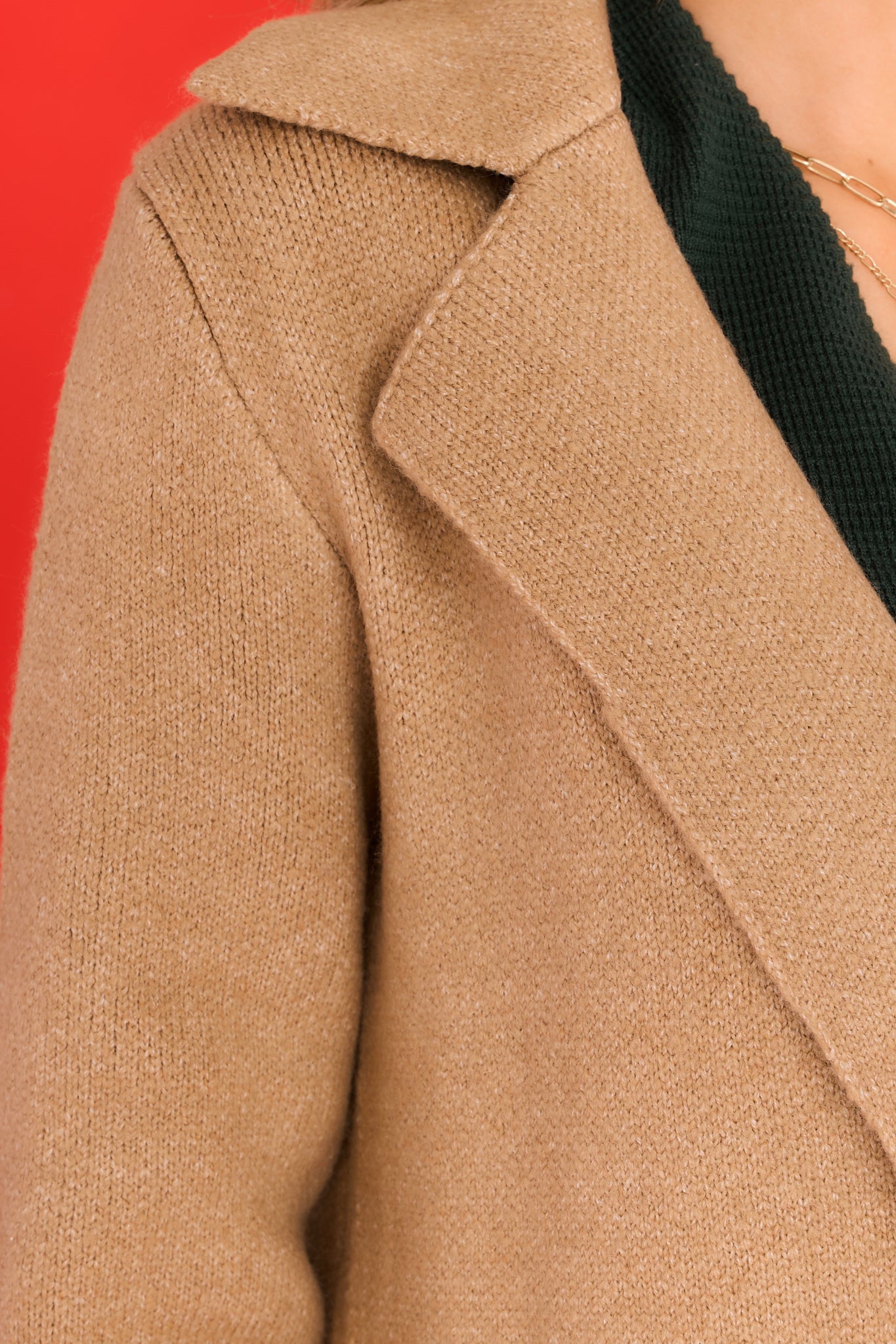 Close up view of this jacket that features a double breasted collar and a soft material.